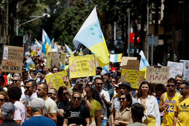 <p>People march on a street during a demonstration for a change in the tourism model in the Canary Islands, in Santa Cruz de Tenerife, Spain, on Saturday </p>
