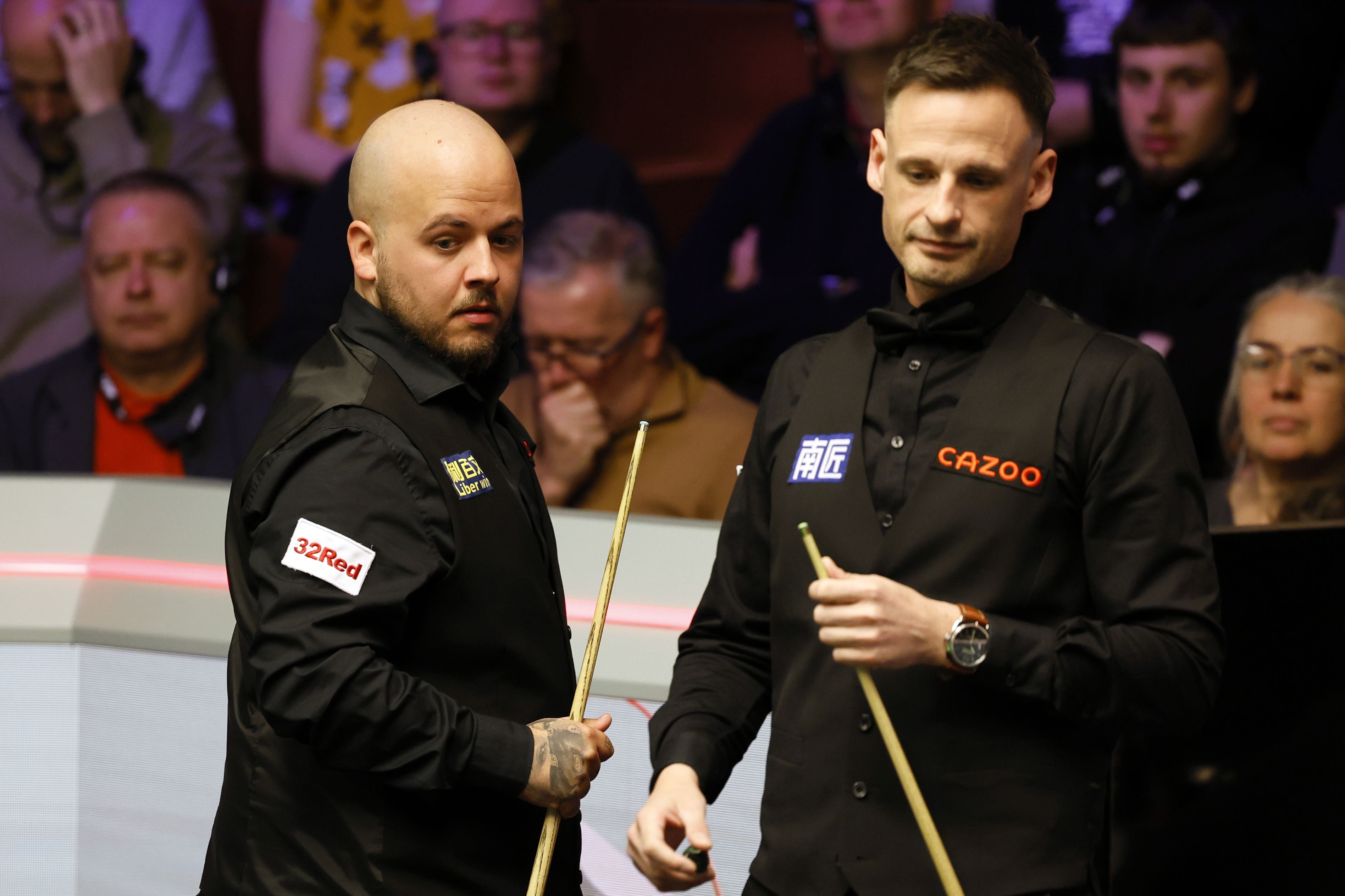 Defending champion Luca Brecel (left) lost to David Gilbert at the Crucible (Richard Sellers/PA)