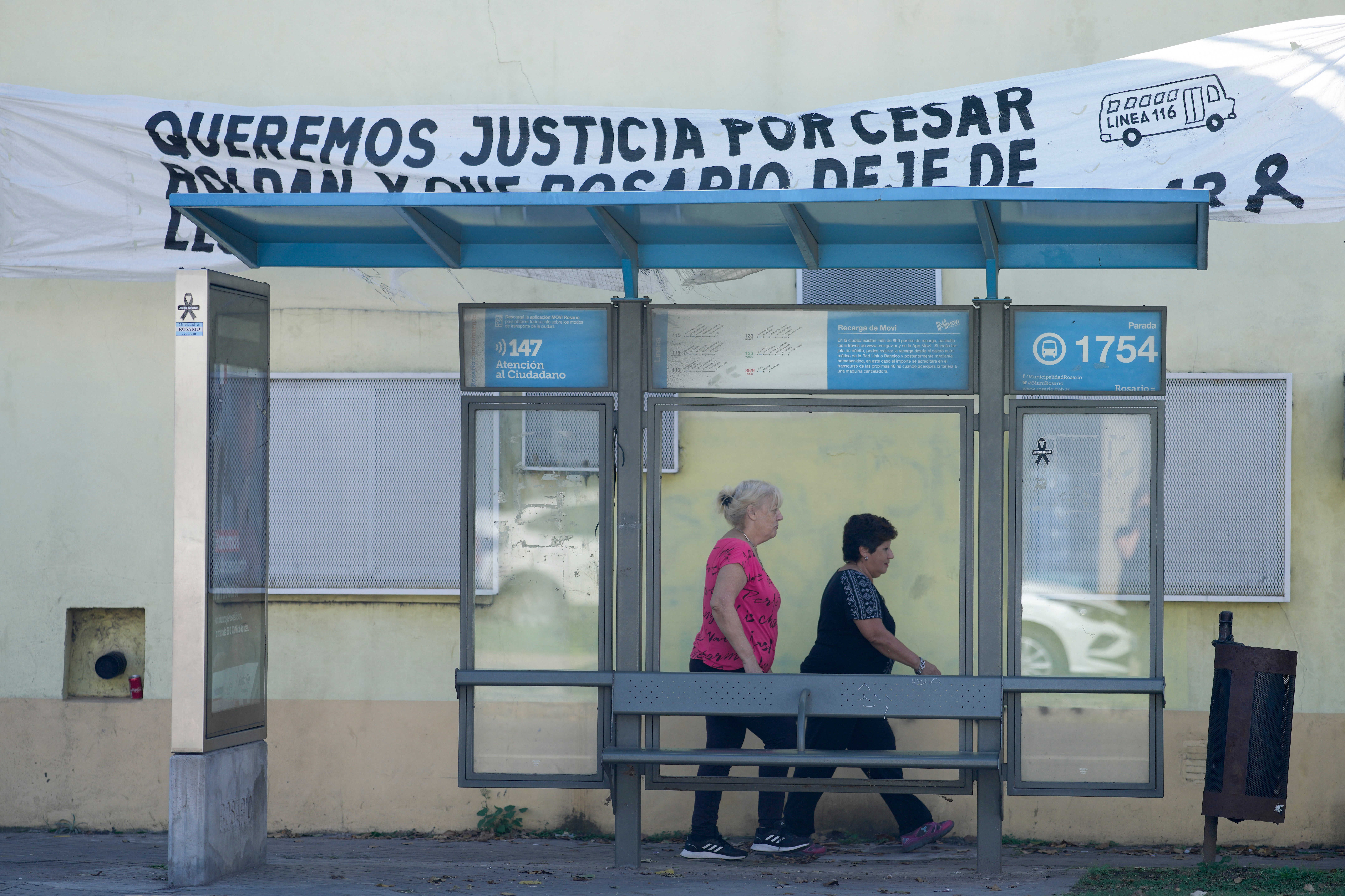 A banner hangs over a bus stop asking for justice regarding the murder of bus driver Cesar Roldan in Rosario