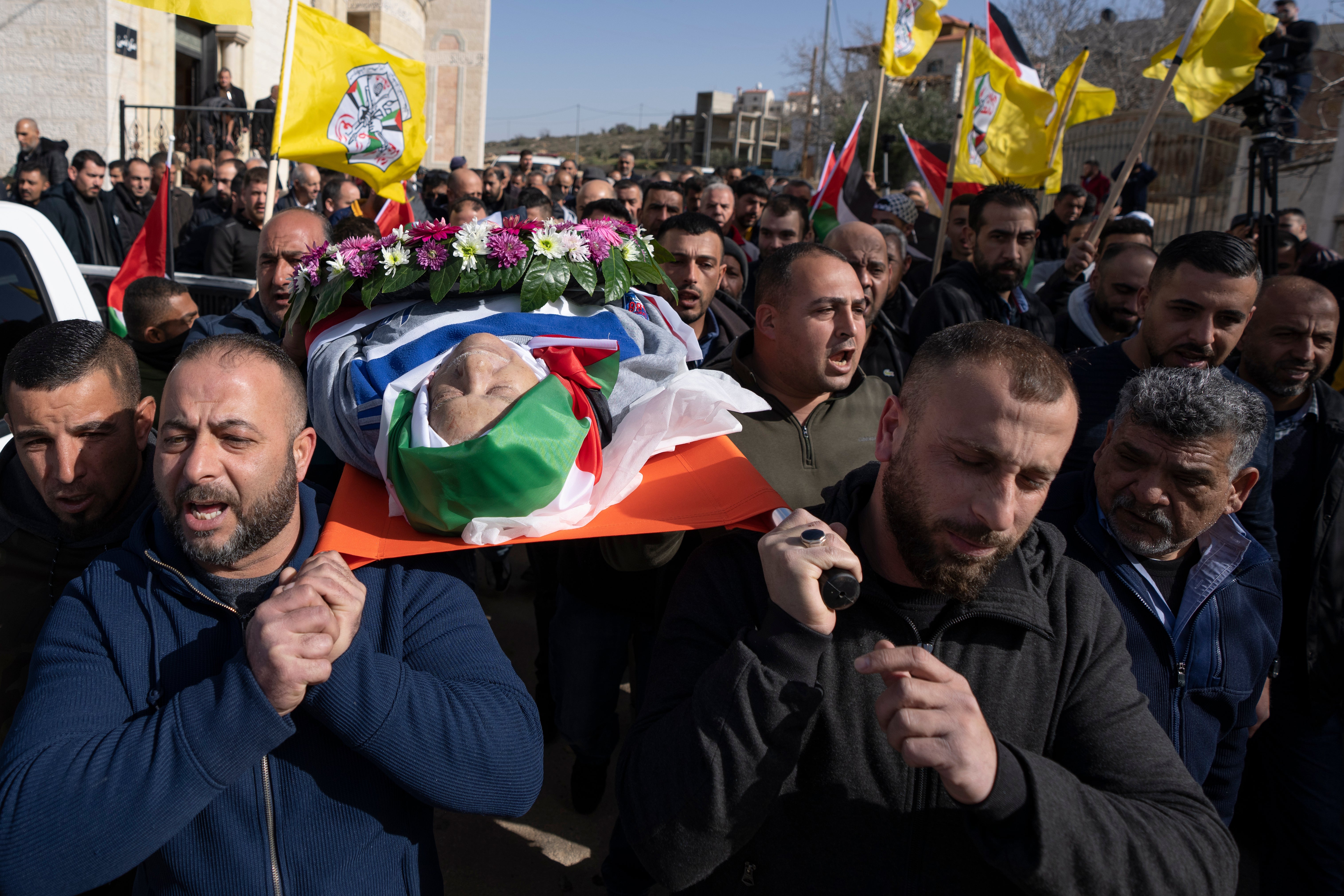 FILE - Mourners carry the body of Omar Assad, during his funeral in the West Bank village of Jiljiliya
