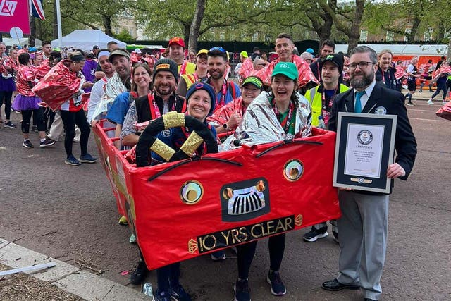 Jackie Scully (front left), was part of a 10-person London bus costume (Guinness World Record/PA)