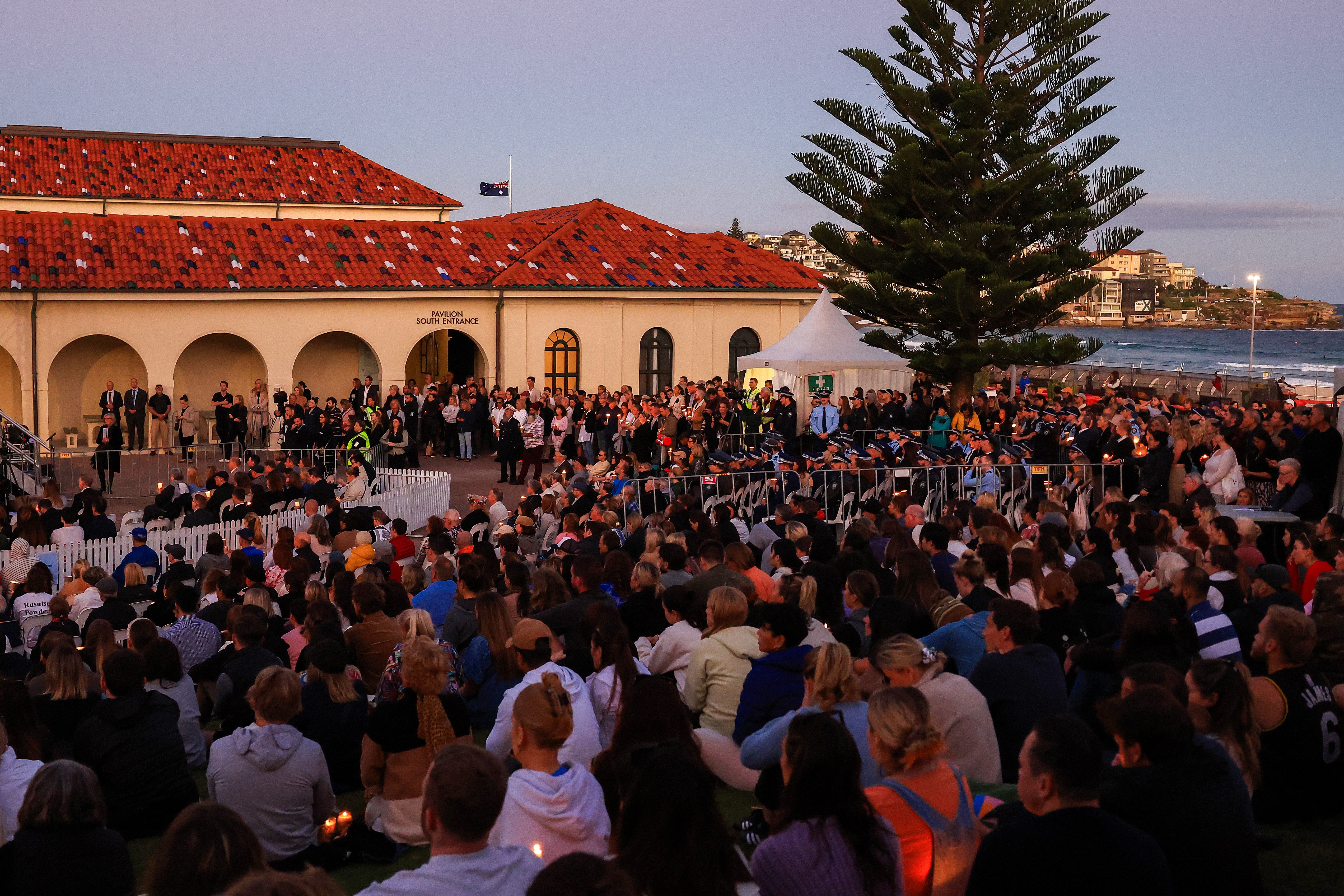 People hold vigil for the victims of Sydney shopping centre attack