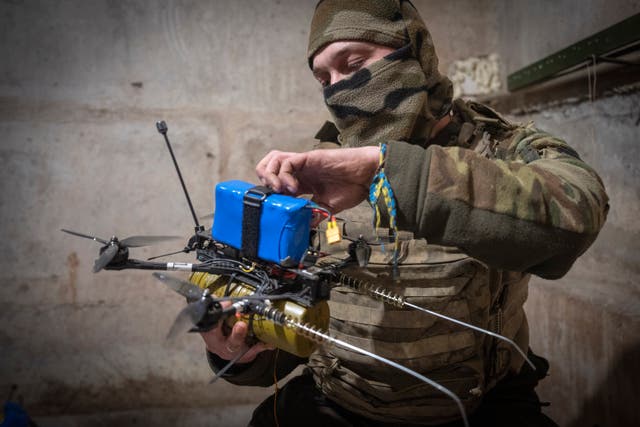 <p>A Ukrainian soldier prepares a FPV drone at the front line</p>