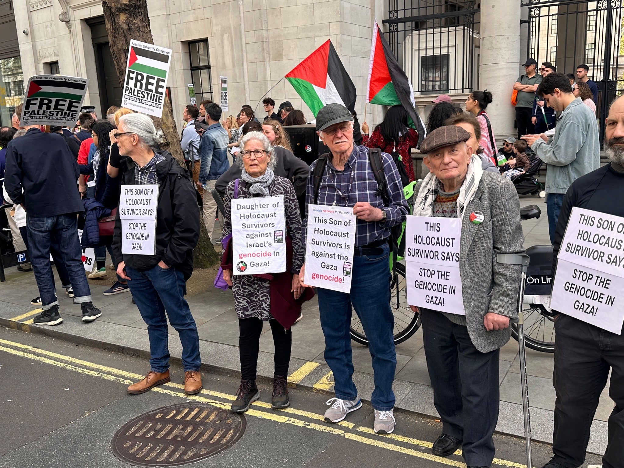 Four people related to Holocaust survivors, and one direct victims of the Holocaust, stand at a pro-Palestine march in support of the demonstration