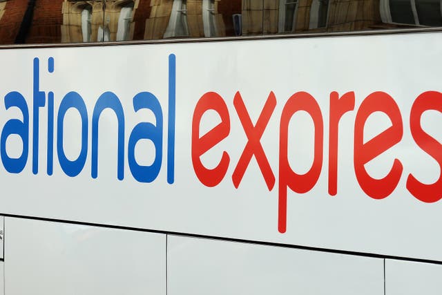 A National Express coach leaves the Victoria Coach Station in central London (John Stillwell/PA)