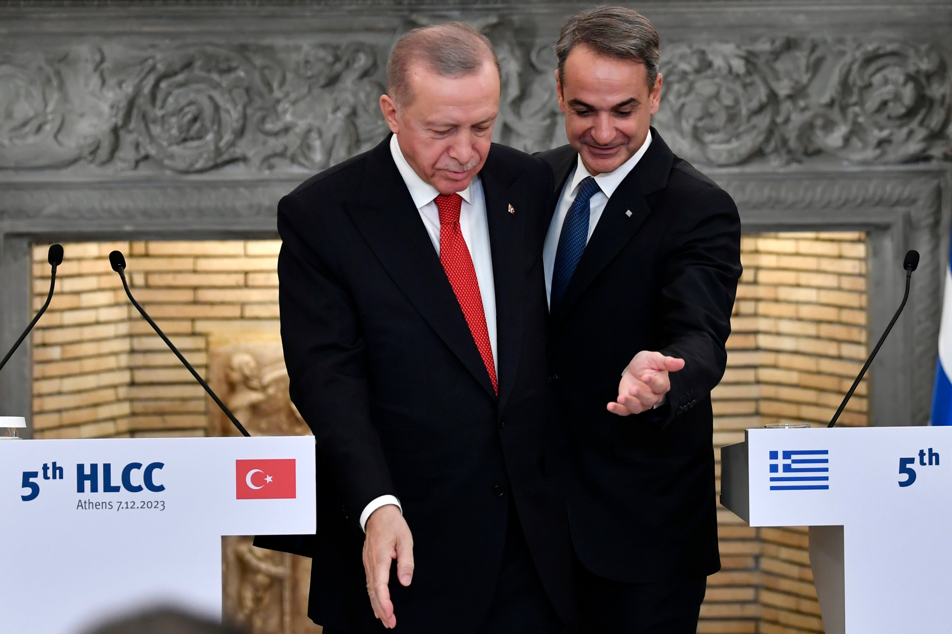 In this December 7, 2023, file photo, Greece's Prime Minister Kyriakos Mitsotakis, right, and Turkey's President Recep Tayyip Erdogan leave after their statements at Maximos Mansion in Athens