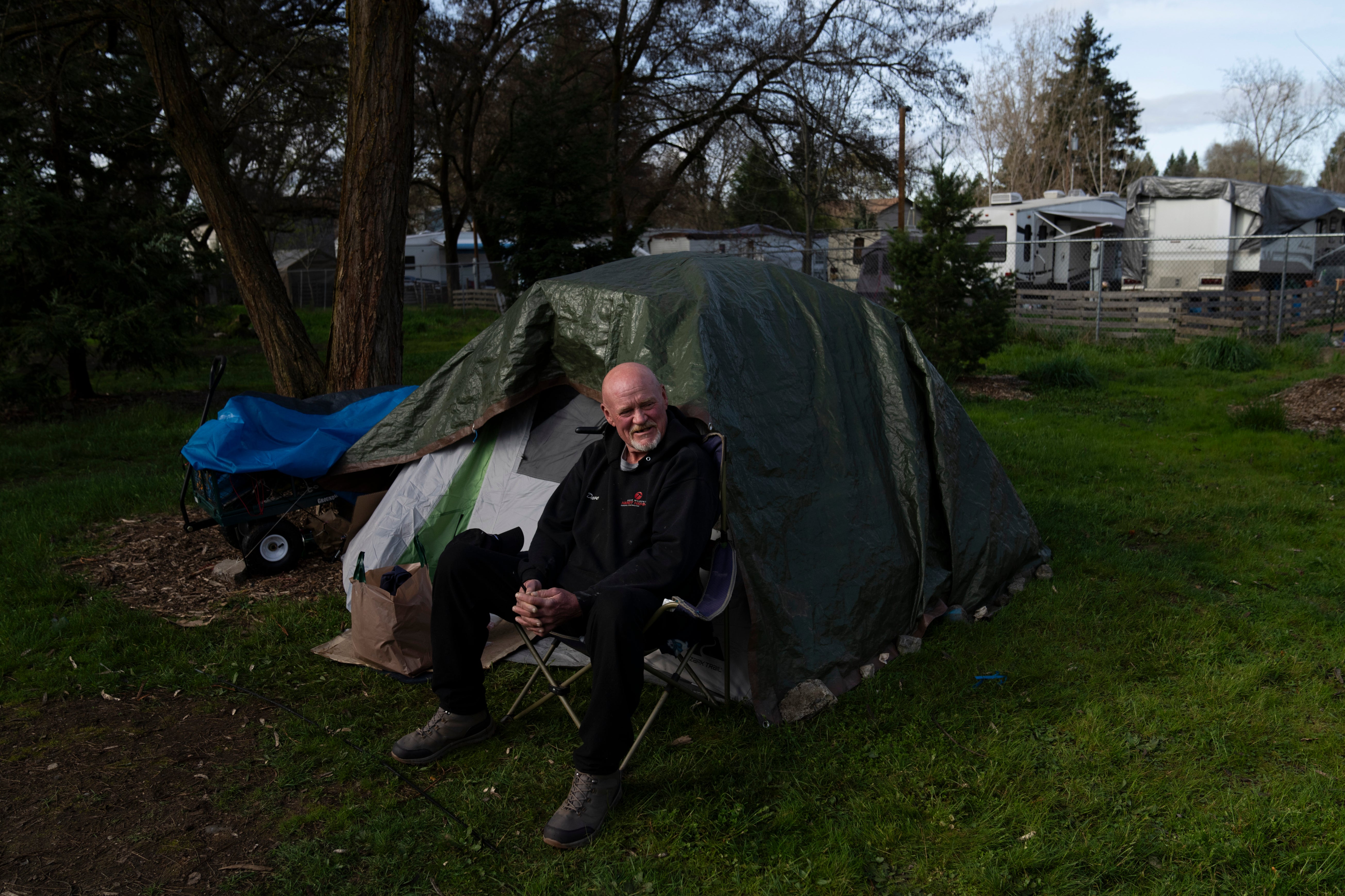David Wilson sits outside his tent at Riverside Park on Thursday, March 21, 2024, in Grants Pass, Oregon. The Supreme Court heard arguments on Monday in a case that could criminalize homeless people across the US