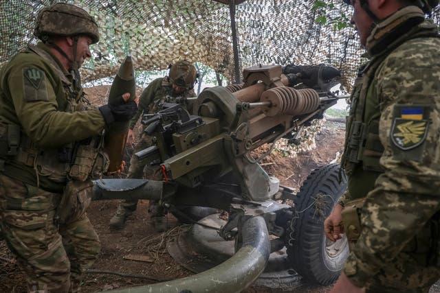 <p>Ukrainian service members fire a L119 howitzer towards Russian troops in the eastern Donetsk region</p>