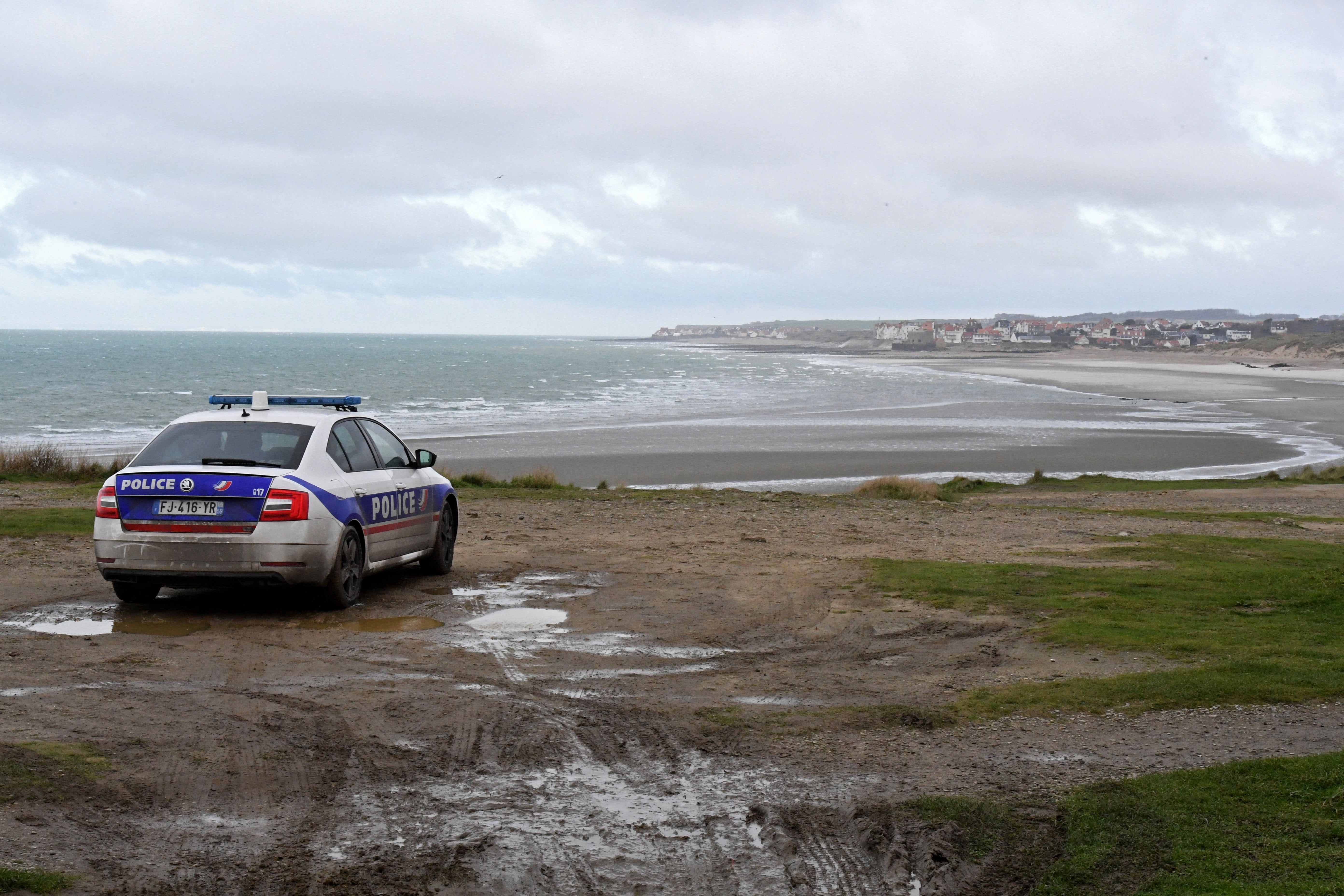 Police officers patrol the beach of Wimereux, on the northern coast of France, from where migrants often leave to attempt the crossing to the UK