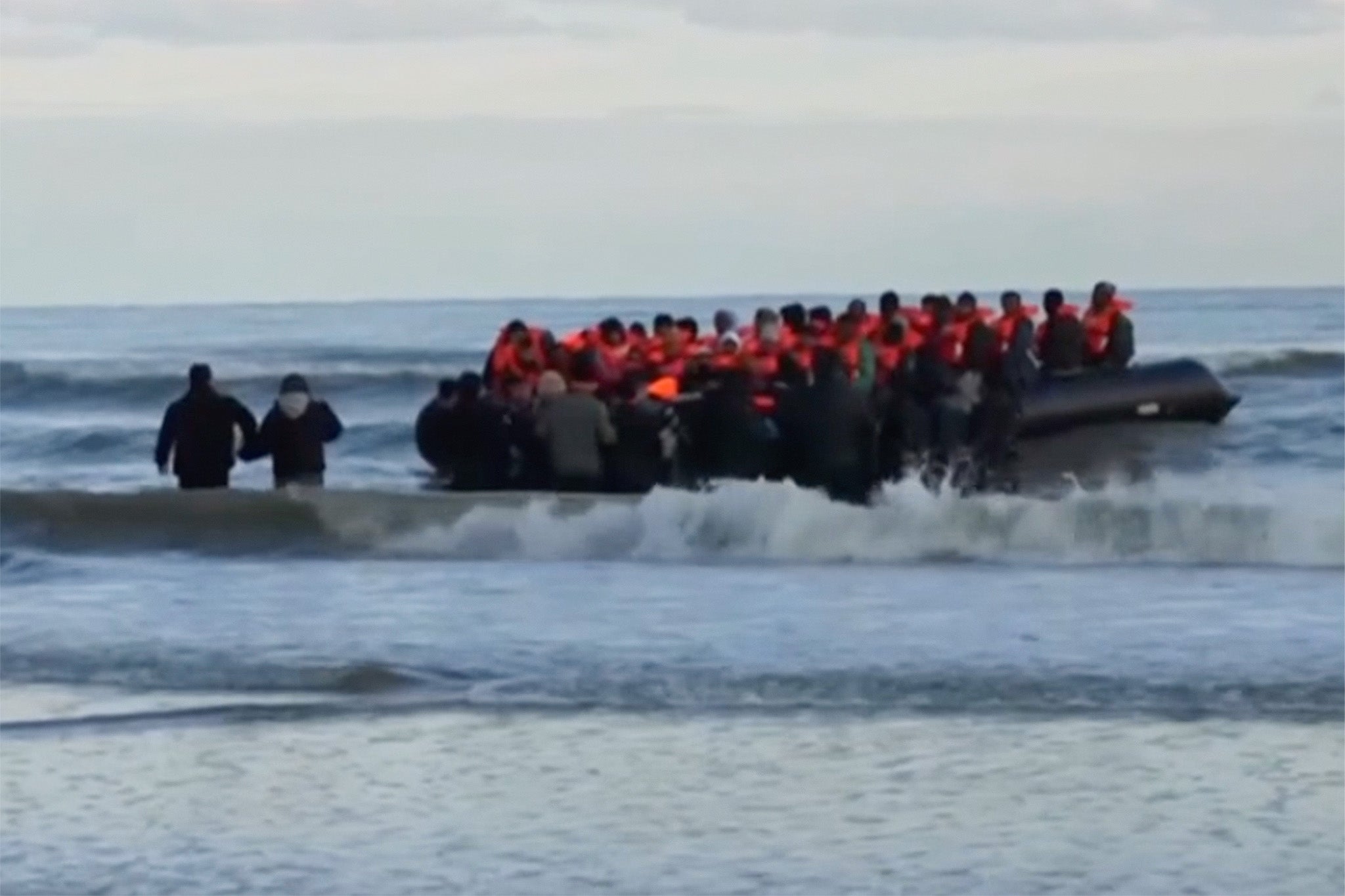Footage from BBC News shows migrants in a small boat at Dunkirk on Tuesday morning after the French coast guard announced five people had died while trying to cross the Channel in a small dinghy