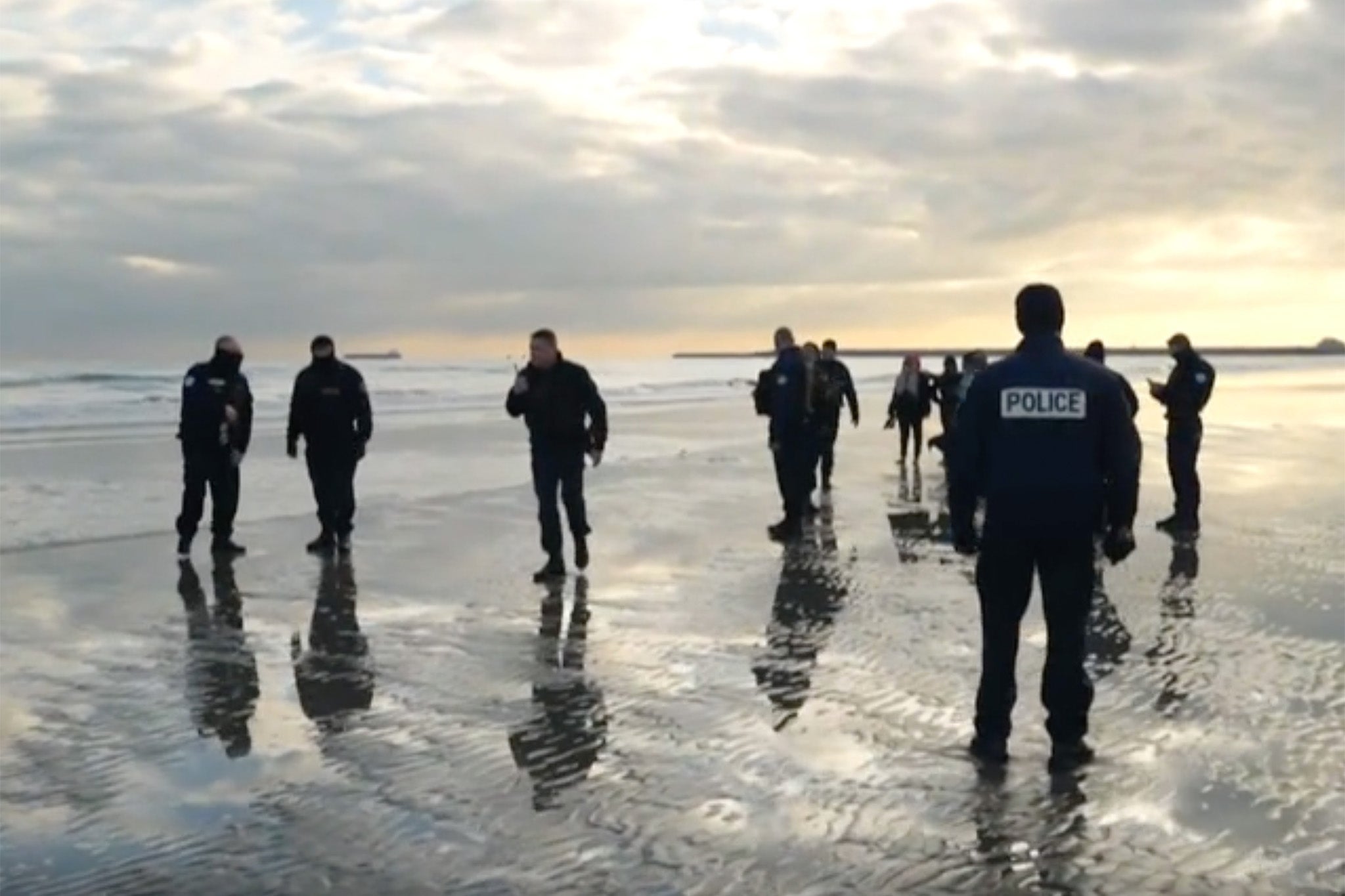 Footage from BBC News shows police on the beach at Dunkirk last Tuesday morning