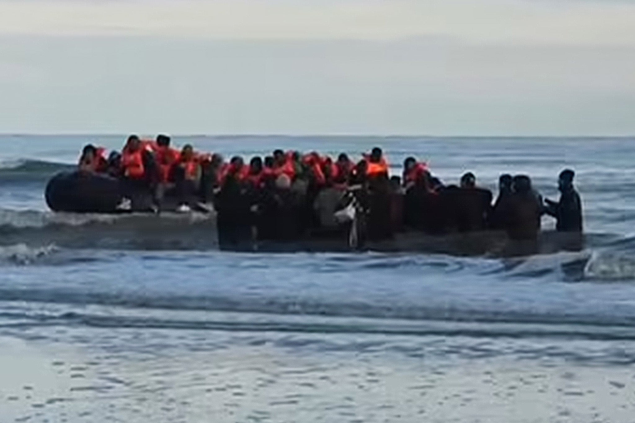 Migrants board a small boat leaving Dunkirk on Tuesday morning - the same day five migrants died attempting the English Channel crossing