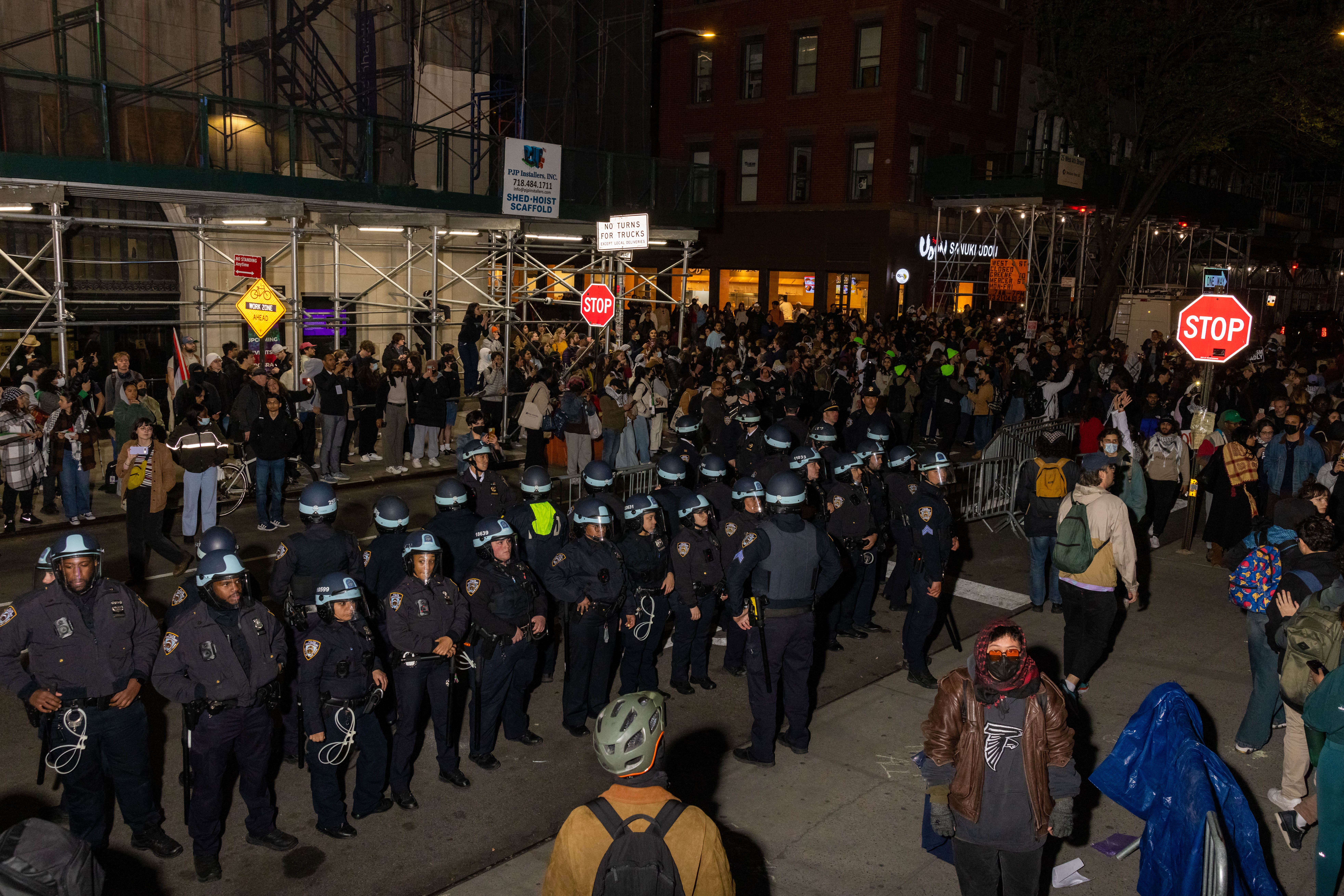 NYPD officers stand by after detaining demonstrators and clearing an encampment set up by pro-Palestine protesters on the campus of New York University