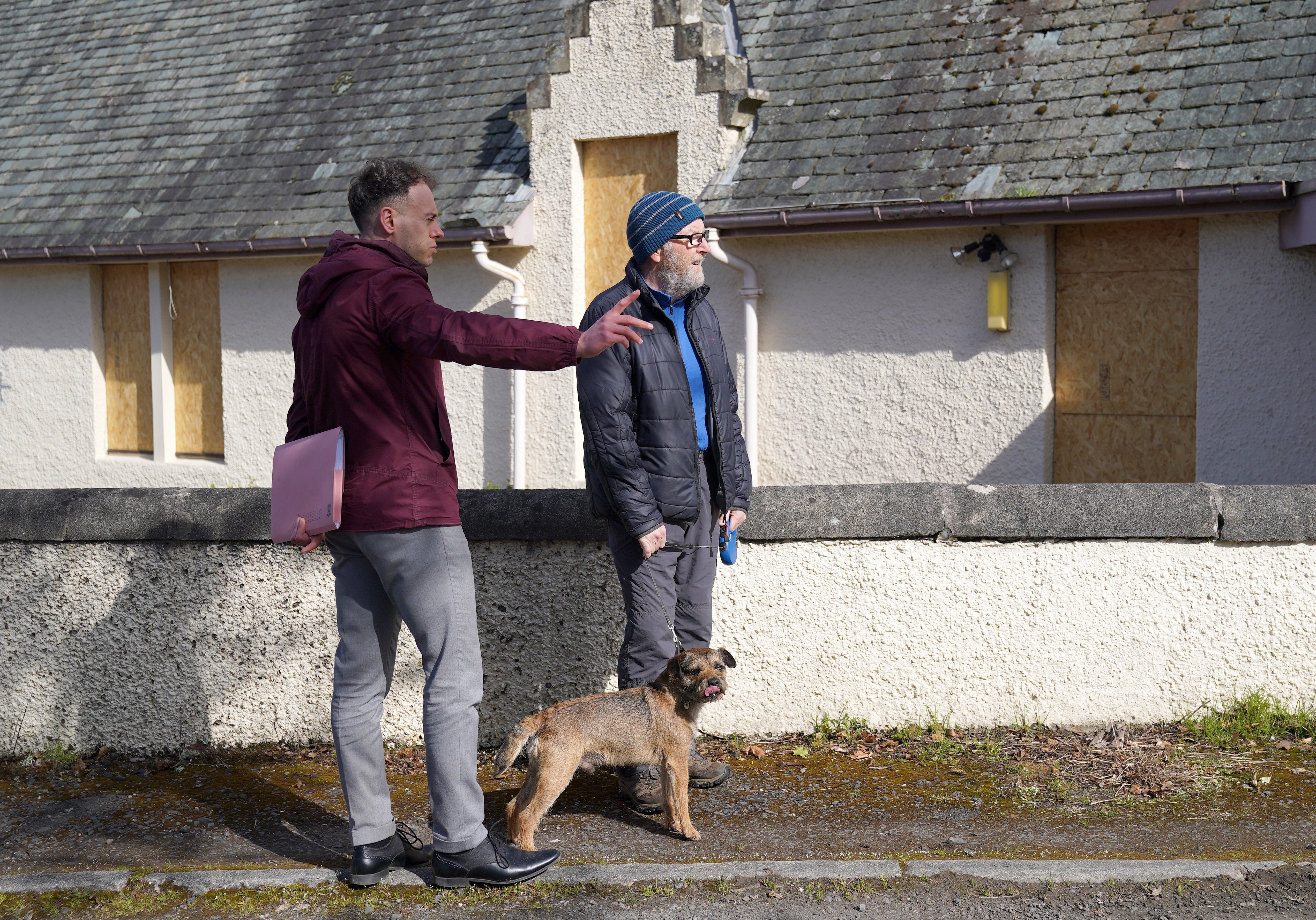Detective Constable Scott Young chats to locals as police make door-to-door enquiries in Aberfeldy, Perth and Kinross, during the investigation into the murder of Brian Low