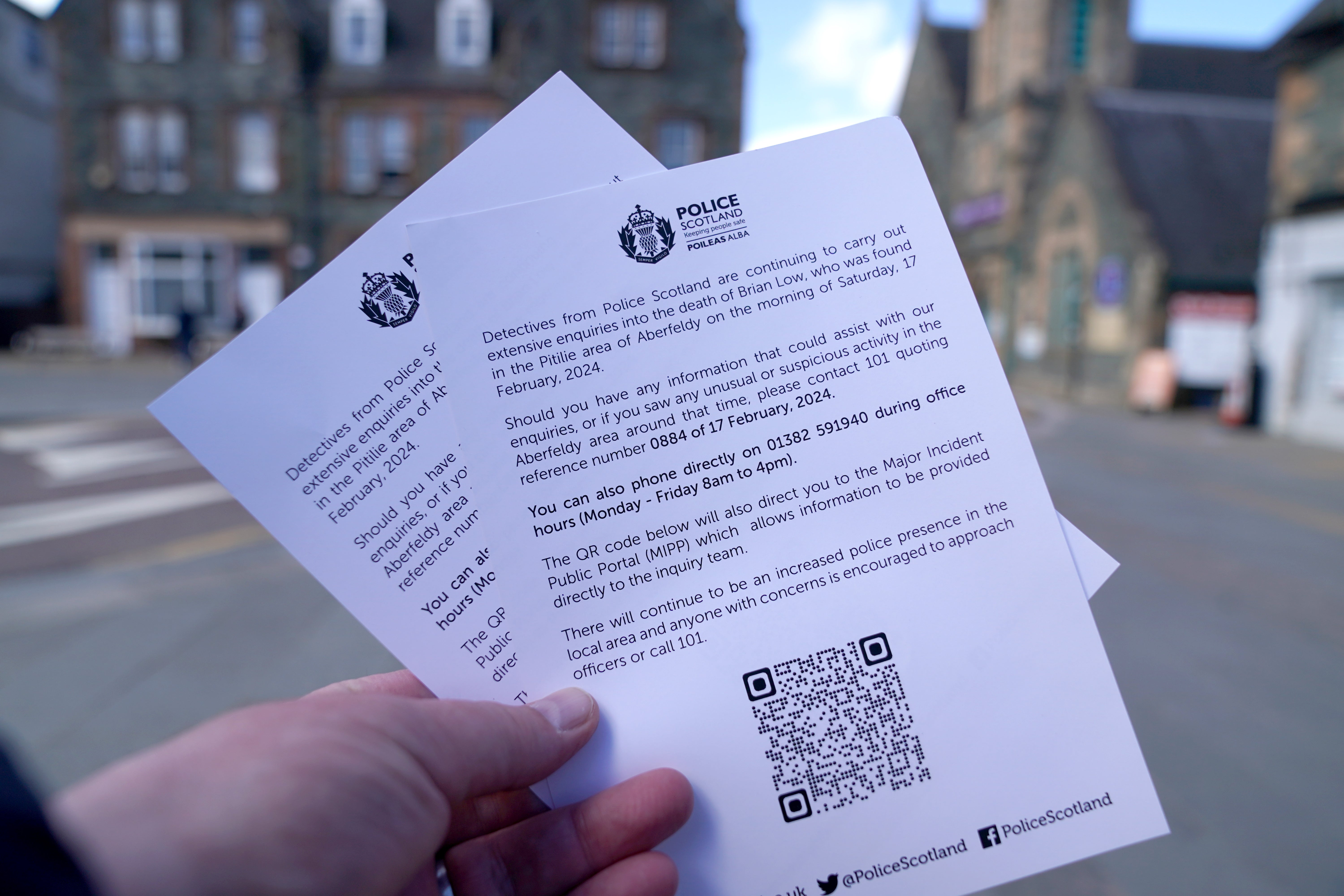 Appeal leaflets are held as police officers make door-to-door enquiries in Aberfeldy, Perth and Kinross