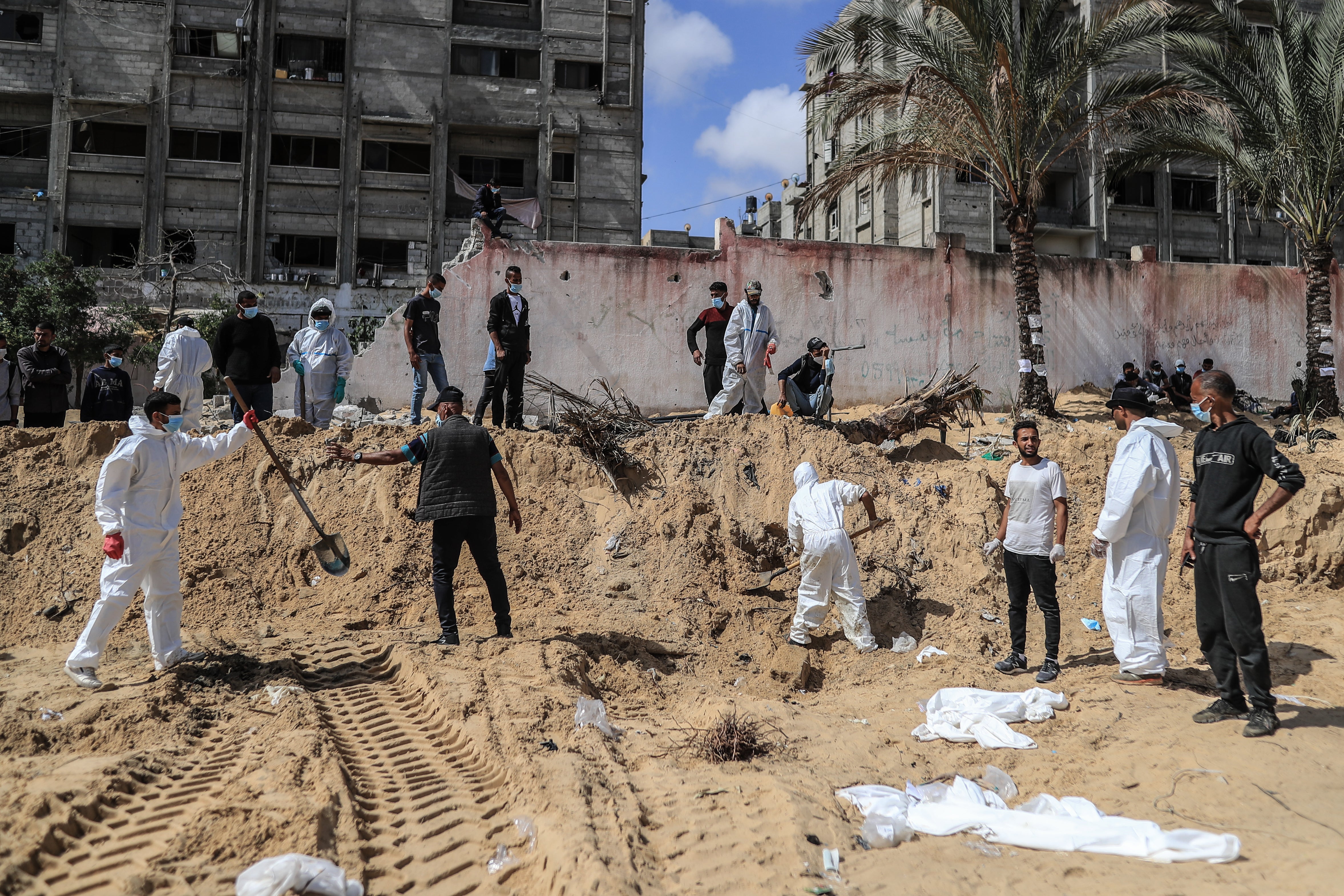 Gazan authorities remove the remains of Palestinians from a mass grave