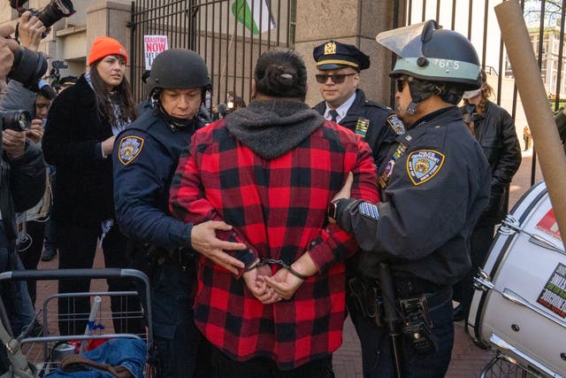 <p>A Pro-Palestine protestor is arrested at the gates of Columbia University on April 22, 2024 in New York City</p>