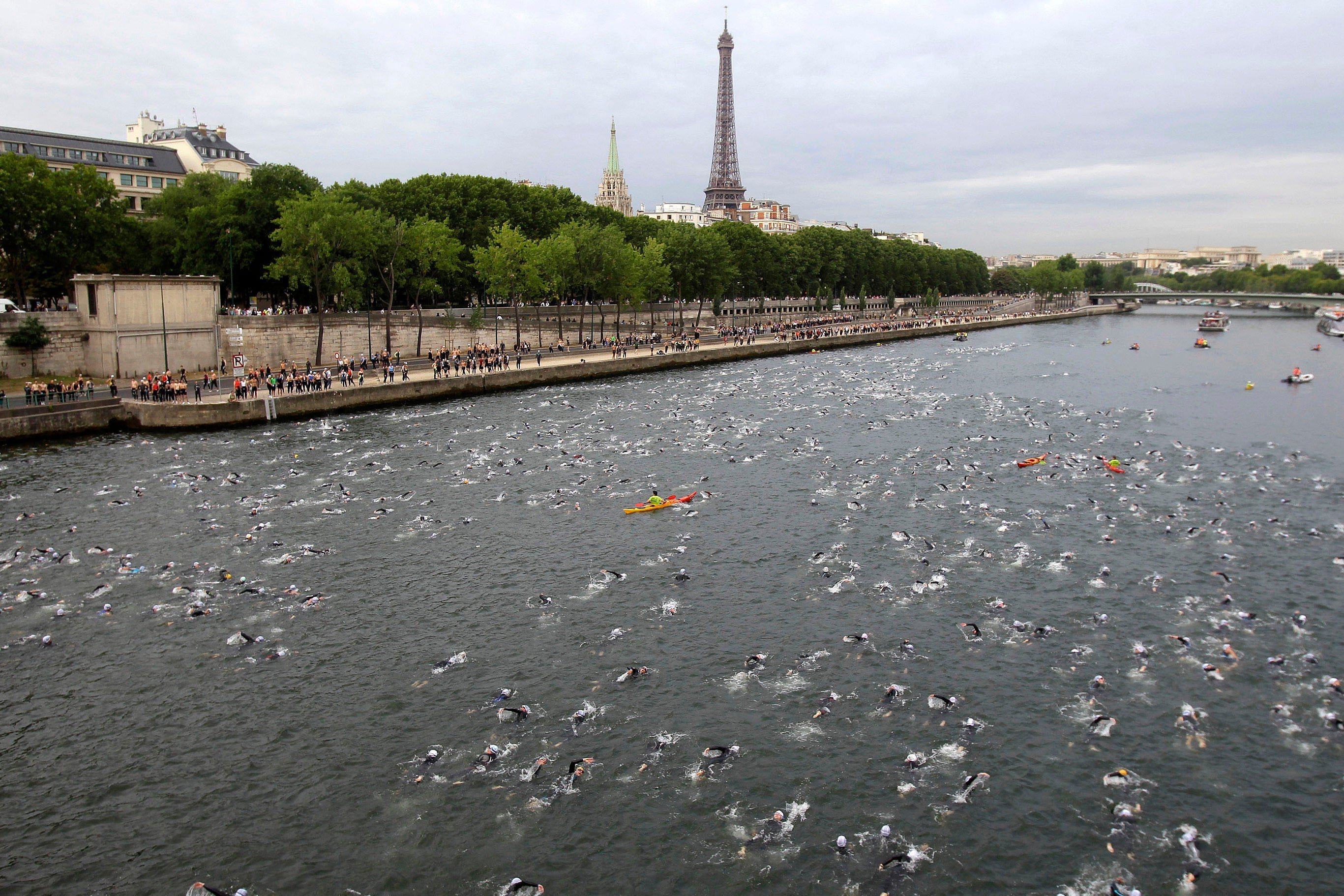 Competitors swim in the Seine River during the Paris Triathlon competition in Paris Sunday, July 10, 2011