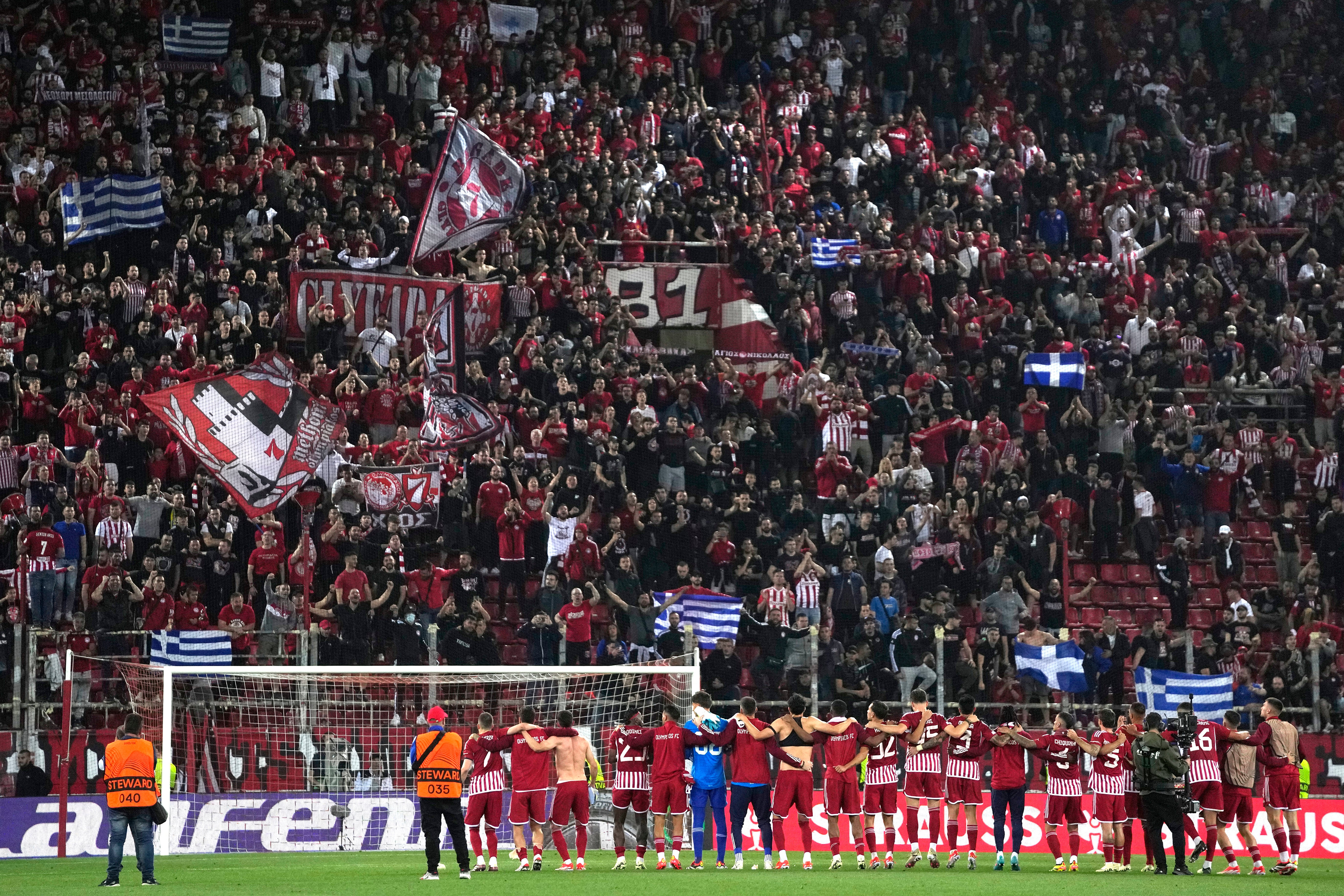 Olympiakos players celebrates in front of their fans after the end of the Europa Conference League quarter final first leg soccer match between Olympiacos and Fenerbahce