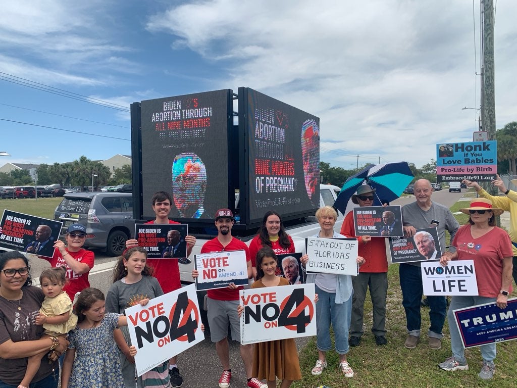 Members of Students for Life Action protest Joe Biden’s campaign stop in Florida on Tuesday. The group is opposed to abortion and supports the state’s six-week ban.