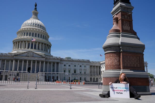 <p>Jennifer Gay, a TikTok content creator, sits outside the US Capitol on 23 April, 2024, in Washington, DC </p>