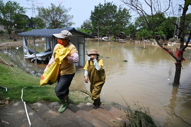 <p>Chinese workers clear debris from a flooded area in Qingyuan in northern Guangdong province </p>