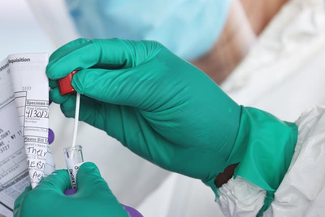 <p>A Health Care Worker seals a coronavirus swab after testing at the Pro Health Urgent Care coronavirus testing site on April 30, 2020 in Wantagh, New York</p>