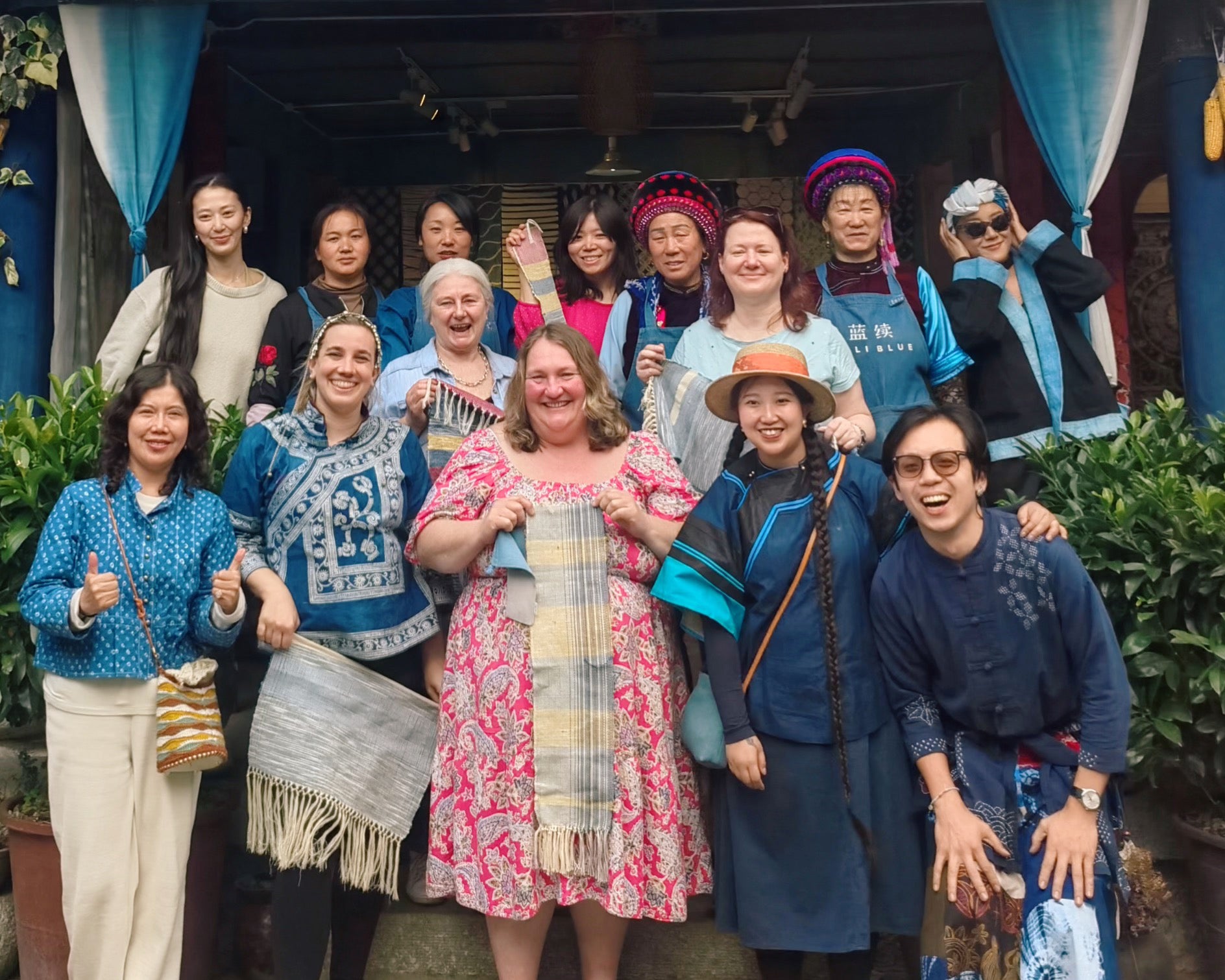 Duan Yiran (second from right, first row) poses with tourists from the UK and local artisans in Dali city, Yunnan province, during a trip she organised in March