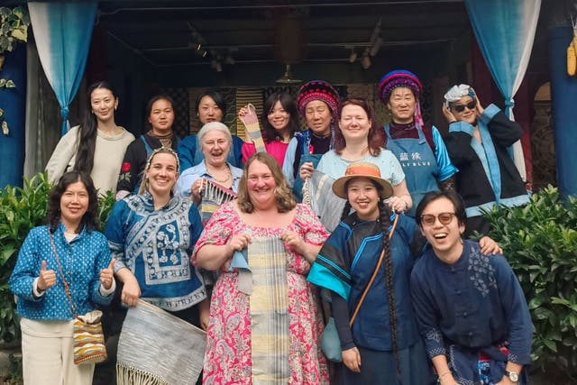 <p>Duan Yiran (second from right, first row) poses with tourists from the UK and local artisans in Dali city, Yunnan province, during a trip she organised in March</p>