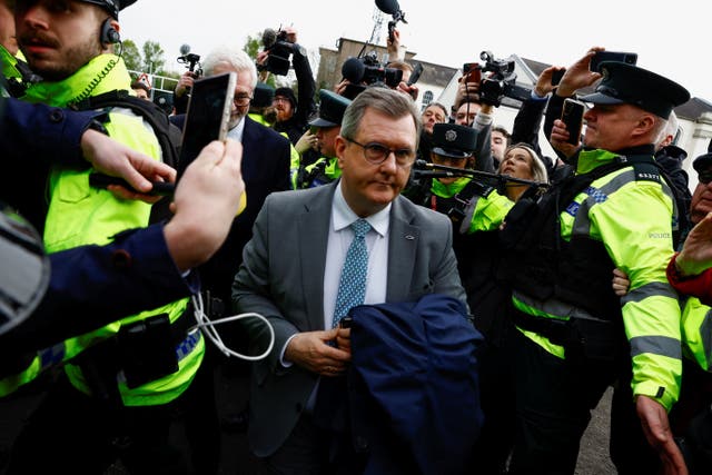 <p>Sir Jeffrey Donaldson arrives in court surrounded by police </p>