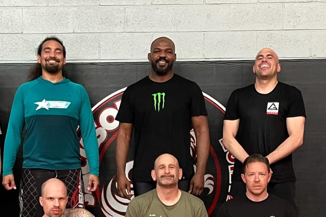 <p>Jon Jones (top centre) is back in training after suffering an injury in October </p>