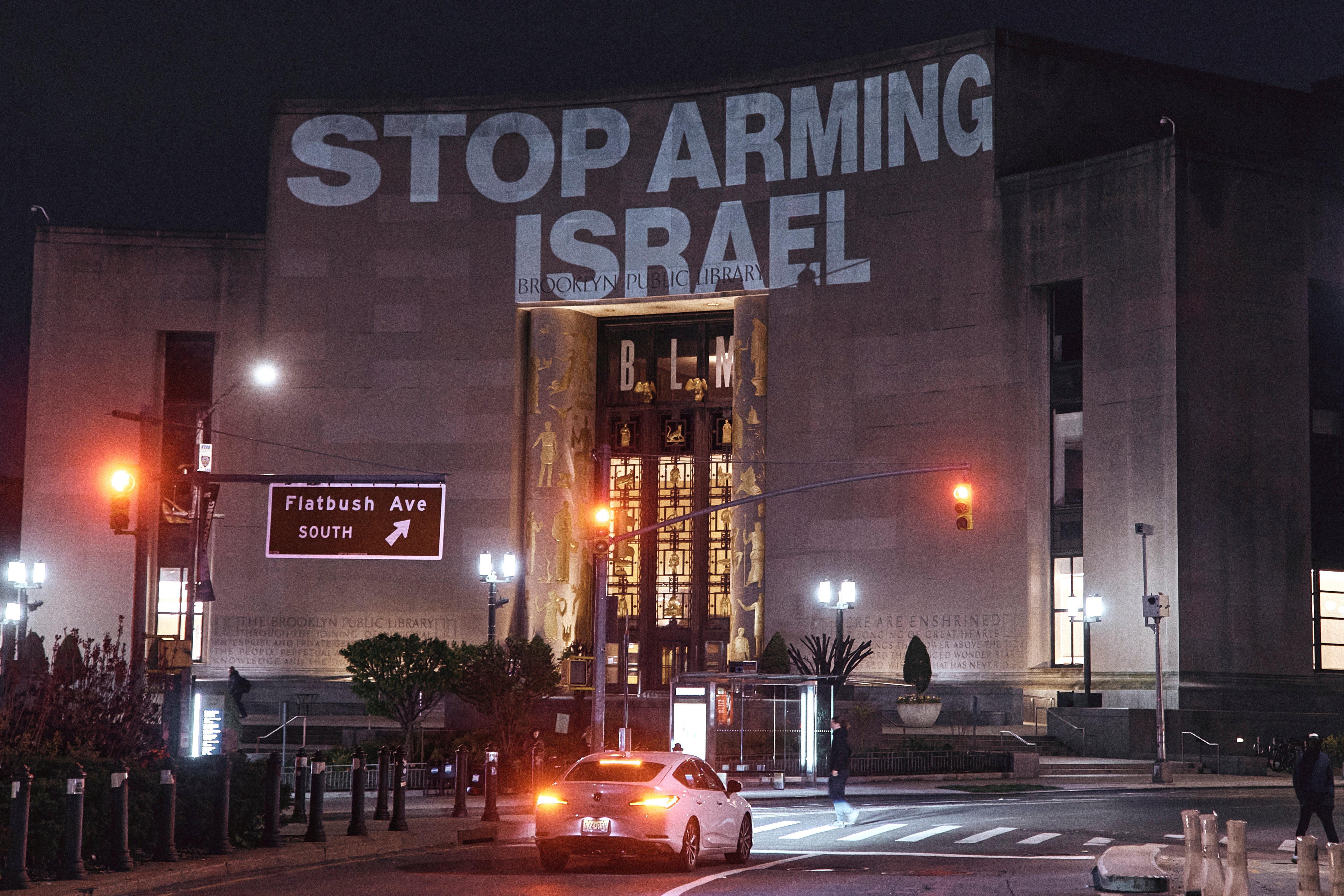 Protesters project a banner on the Brooklyn Public Library during a pro-Palestinian demonstration demanding a permanent ceasefire in Gaza