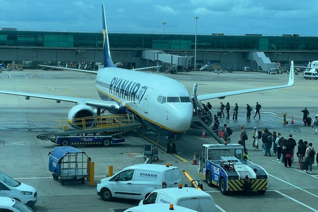 <p>Going places: Passengers boarding Boeing 737-800 belonging to Ryanair at London Stansted airport </p>