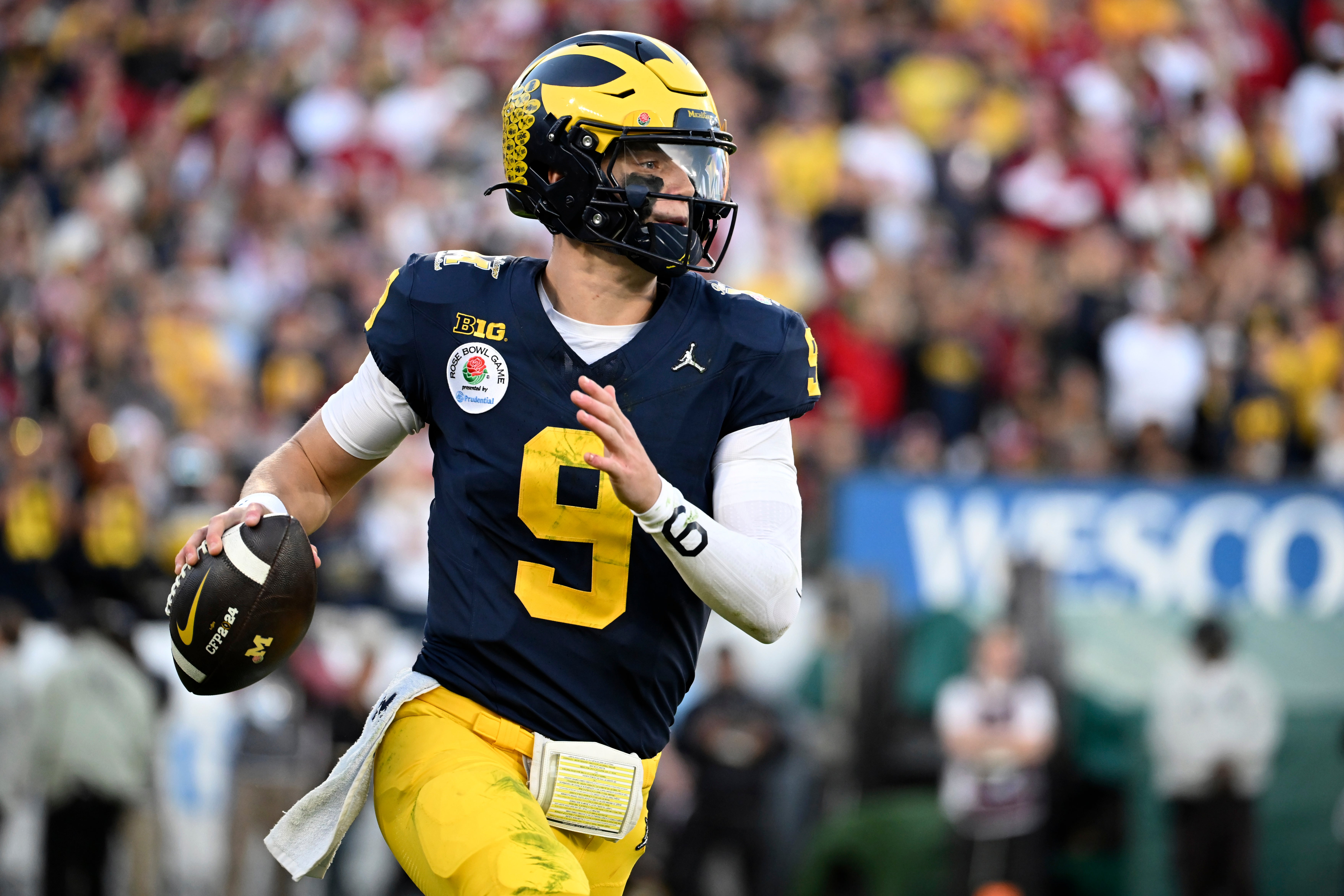 Michigan quarterback J.J. McCarthy (9) rolls out during the second half of the Rose Bowl