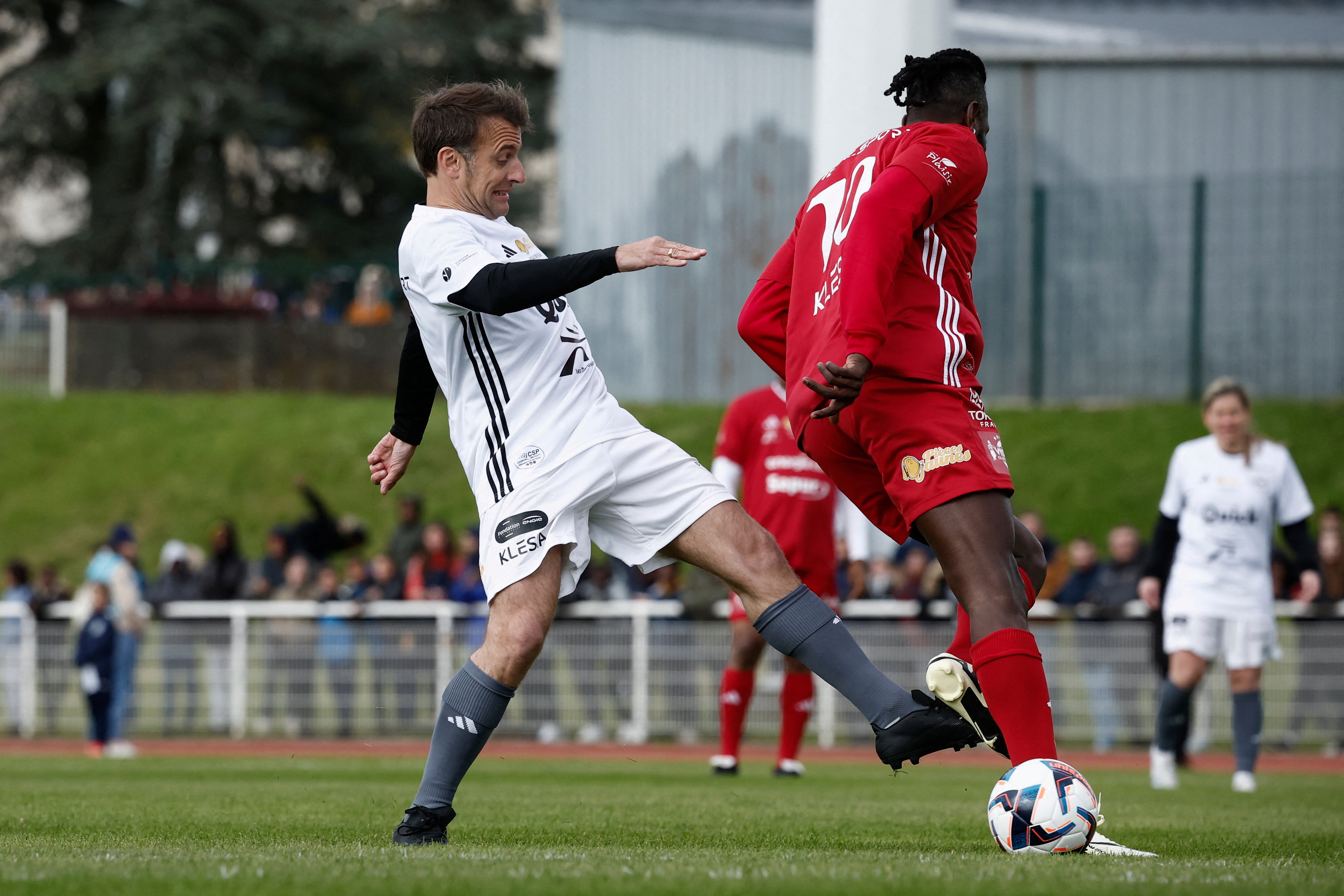 French President Emmanuel Macron,left, participates in the Varietes Club charity football