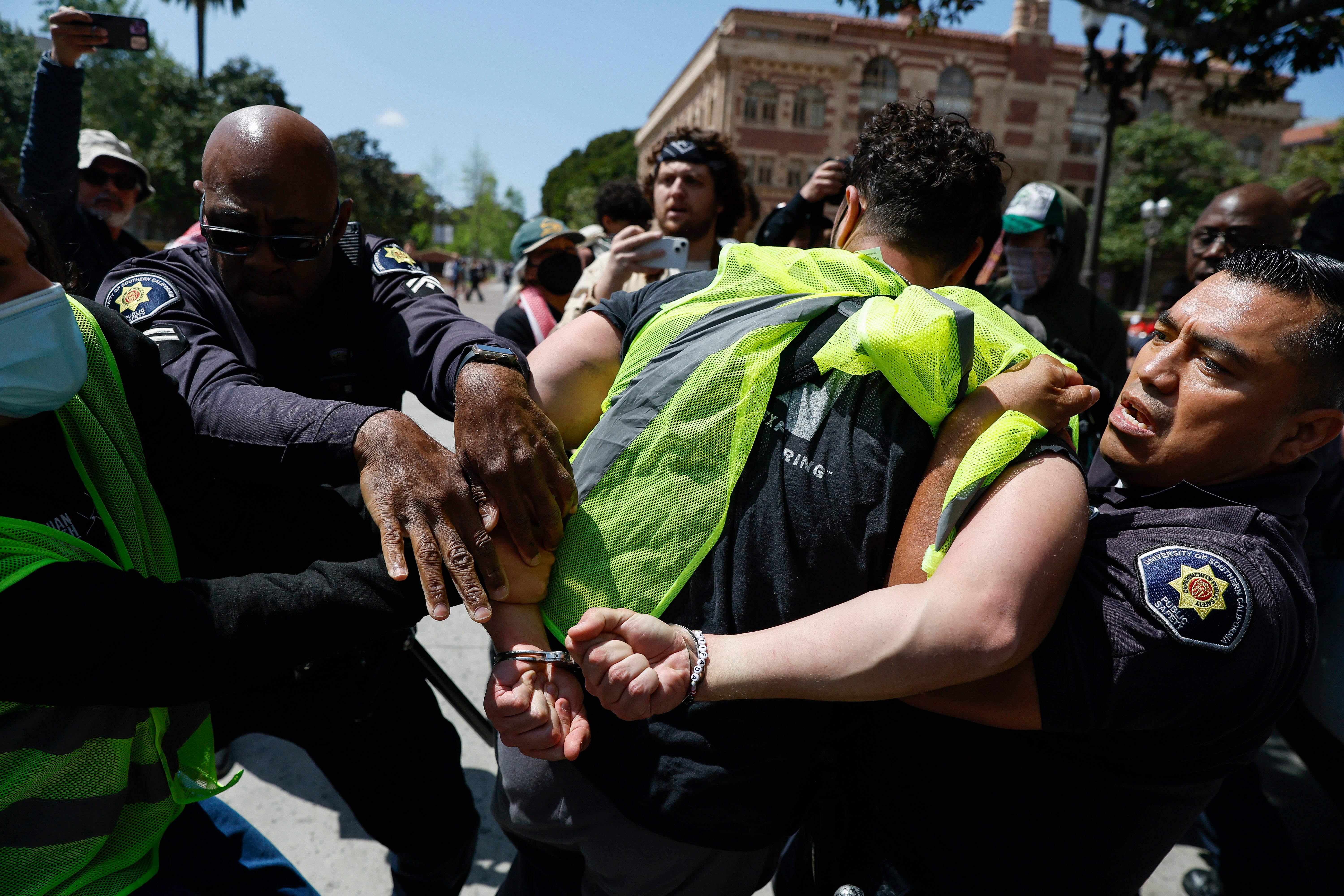 USC Public Safety Officers detain a protester during a Gaza solidarity occupation on campus to advocate for Palestine in Los Angeles, California