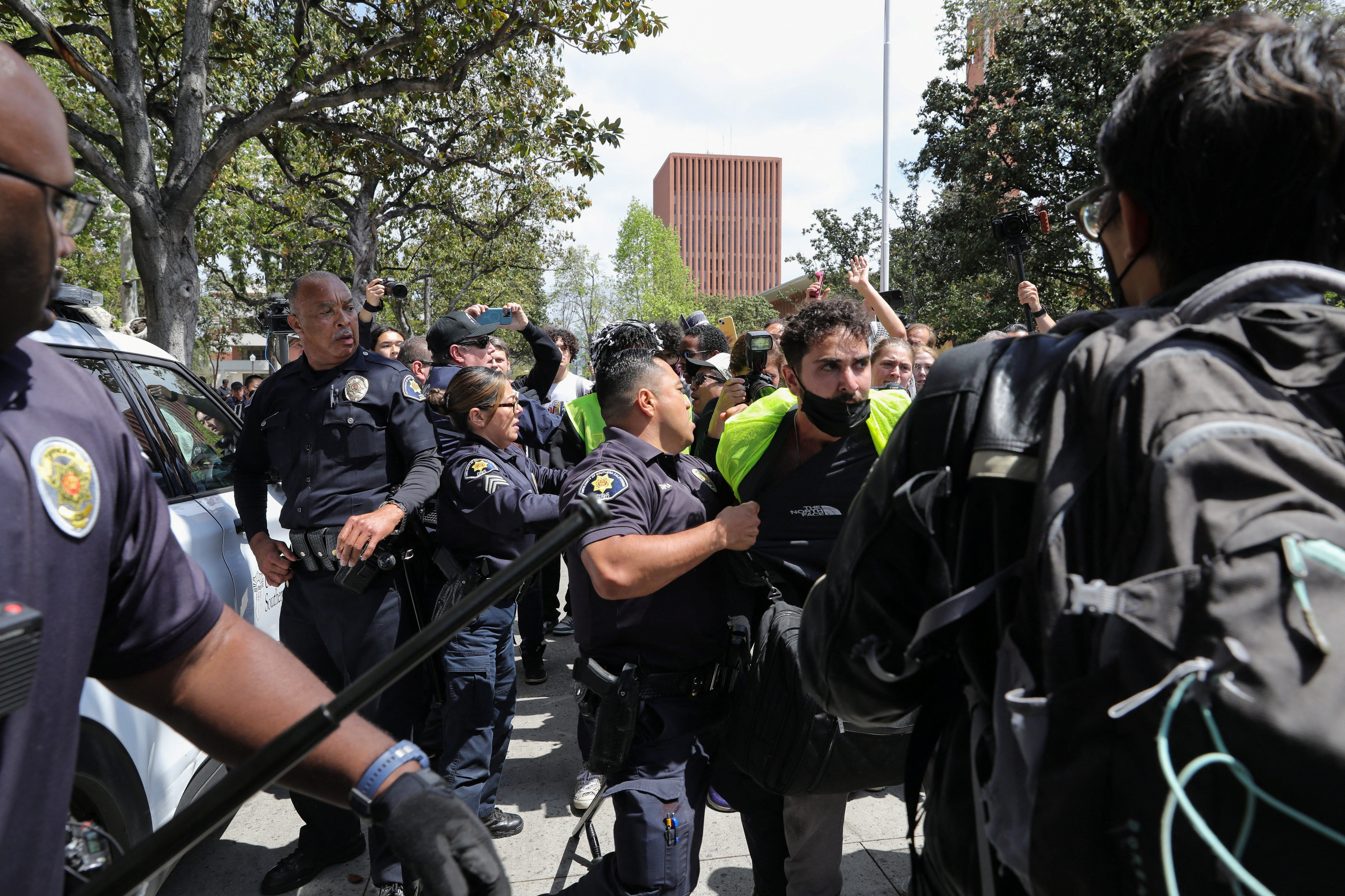 USC Safety officers try to disperse students who protest in support of Palestinians, at the University of Southern California's Alumni Park, during demonstraions on 24 April