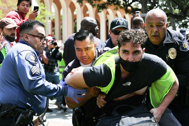 <p>USC public safety officers detain a pro-Palestine demonstrator during clashes after officers attempted to take down an encampment in support of Gaza at the University of Southern California on 24 April 2024 in Los Angeles, California.</p>