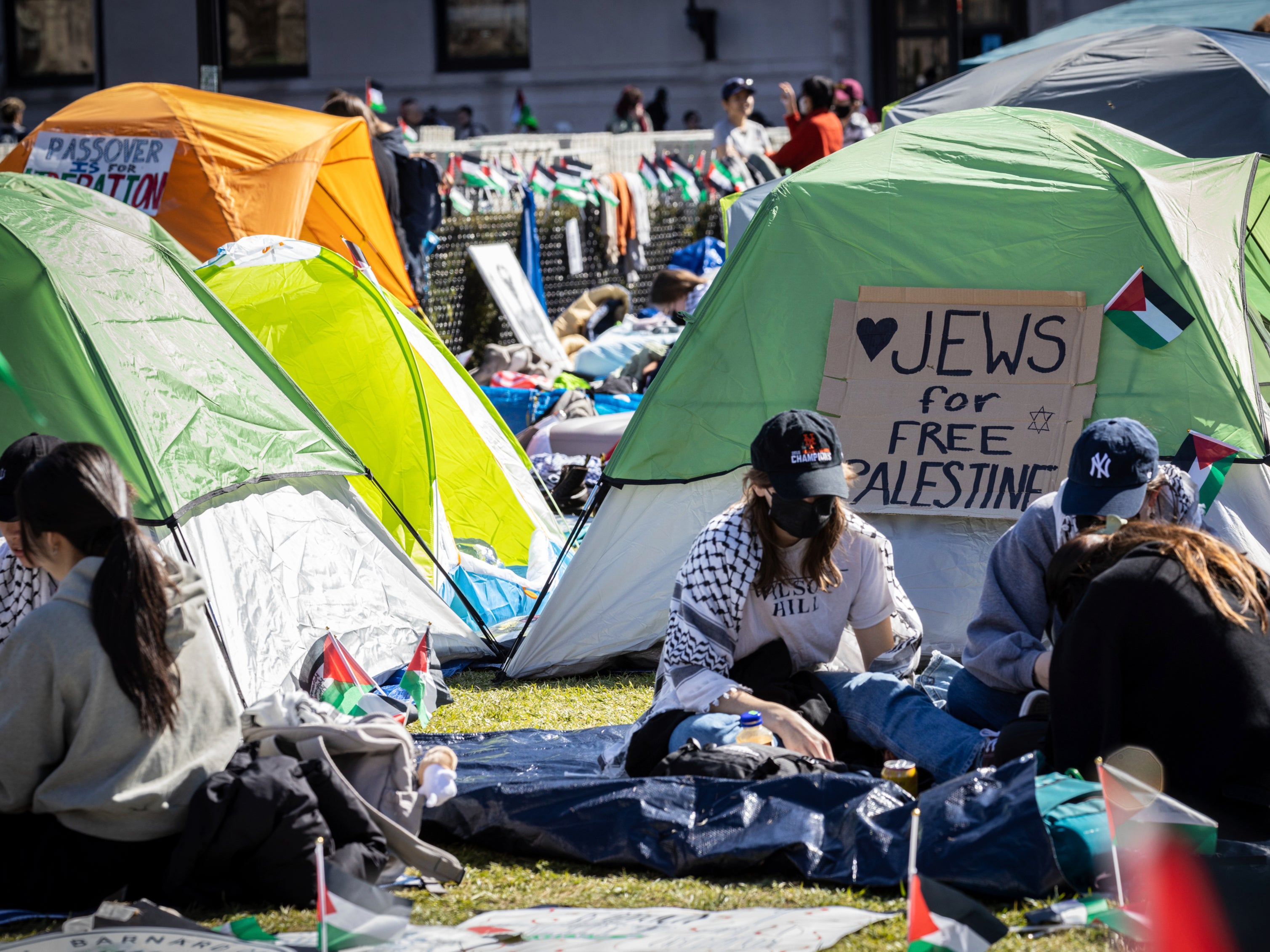 <p>Student protesters sit in front of a tent during the Pro-Palestinian protest at the Columbia University campus in New York, Monday April 22, 2024. </p>