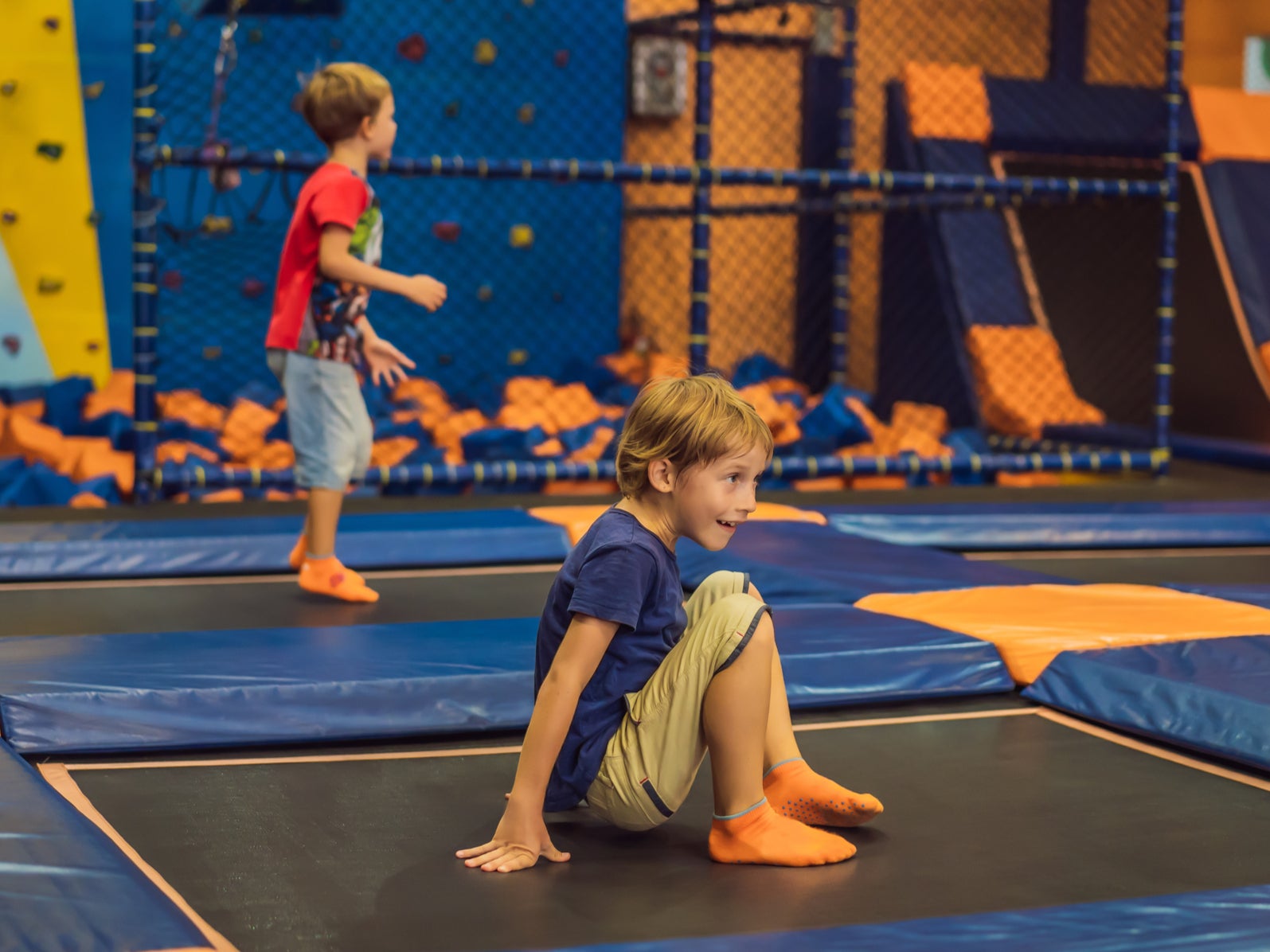 <p>A boy jumping on a trampoline in trampoline park.</p>