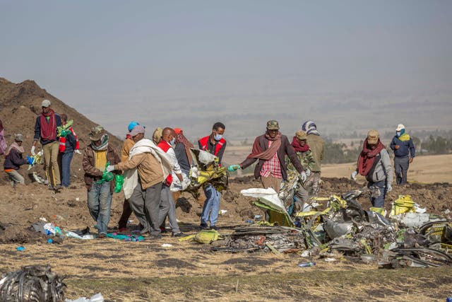 <p>Rescuers work at the scene of an Ethiopian Airlines flight of a Boeing 737 Max 8 plane crash near Bishoftu, Ethiopia in March 2019</p>