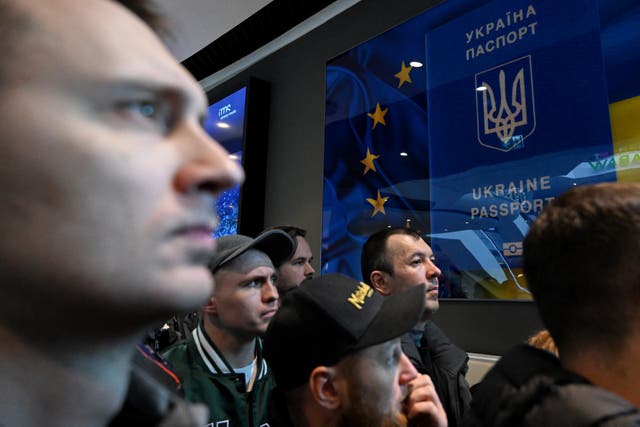 <p>Ukrainians gather in front of closed passport service point at shopping centre in Warsaw, Poland</p>