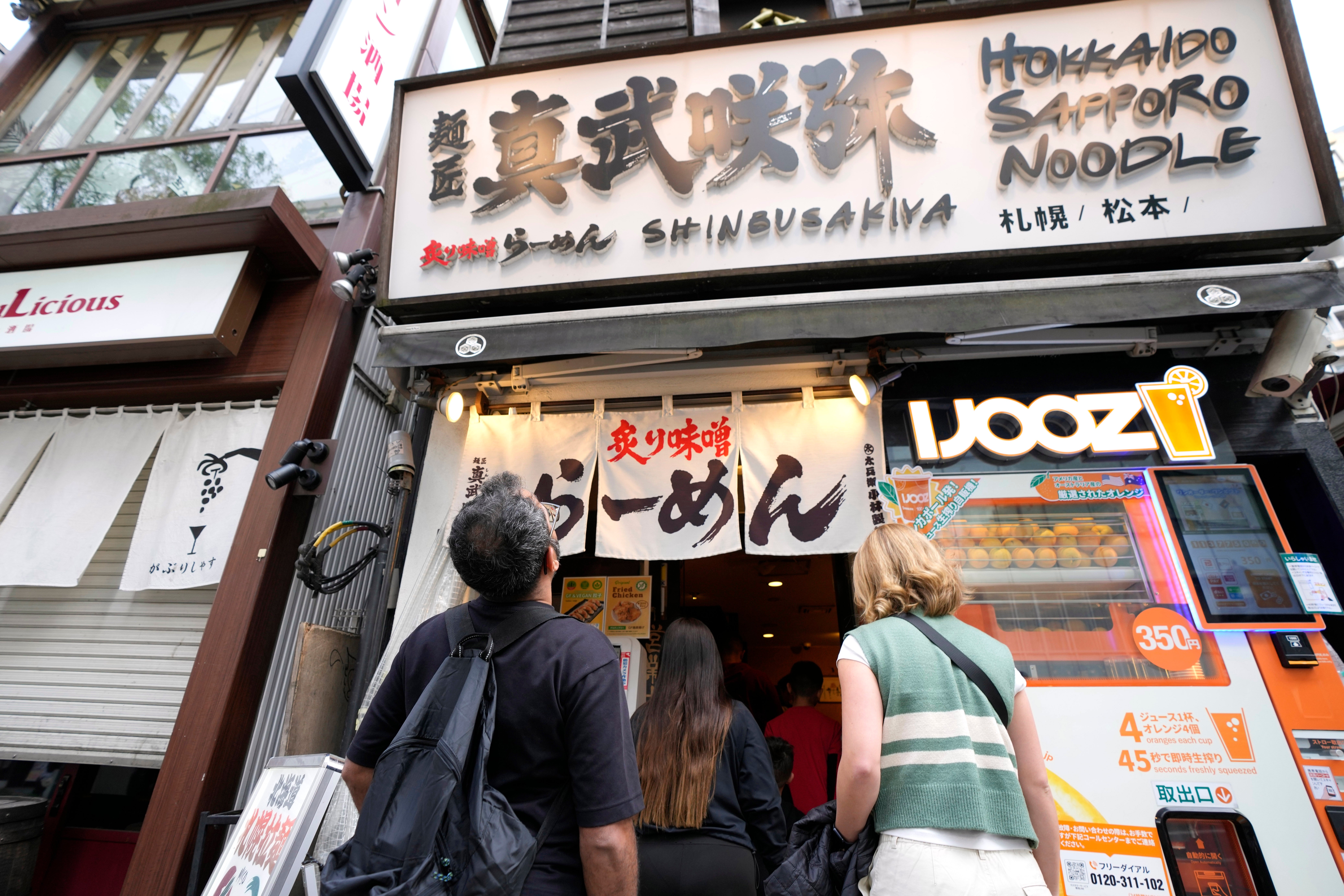 Participants of Tokyo Ramen Tours enter Shinbusakiya, a ramen shop which offers ‘Hokkaido classics’ at Shibuya district