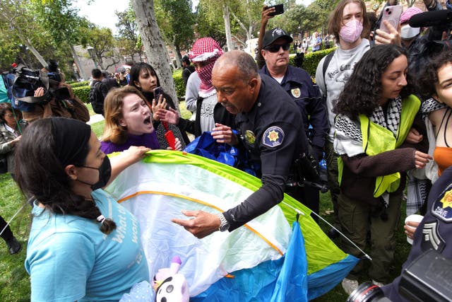 <p>University of Southern California protesters argue with public safety officers as they try to remove tents at the campus' Alumni Park during a pro-Palestinian occupation on Wednesday</p>