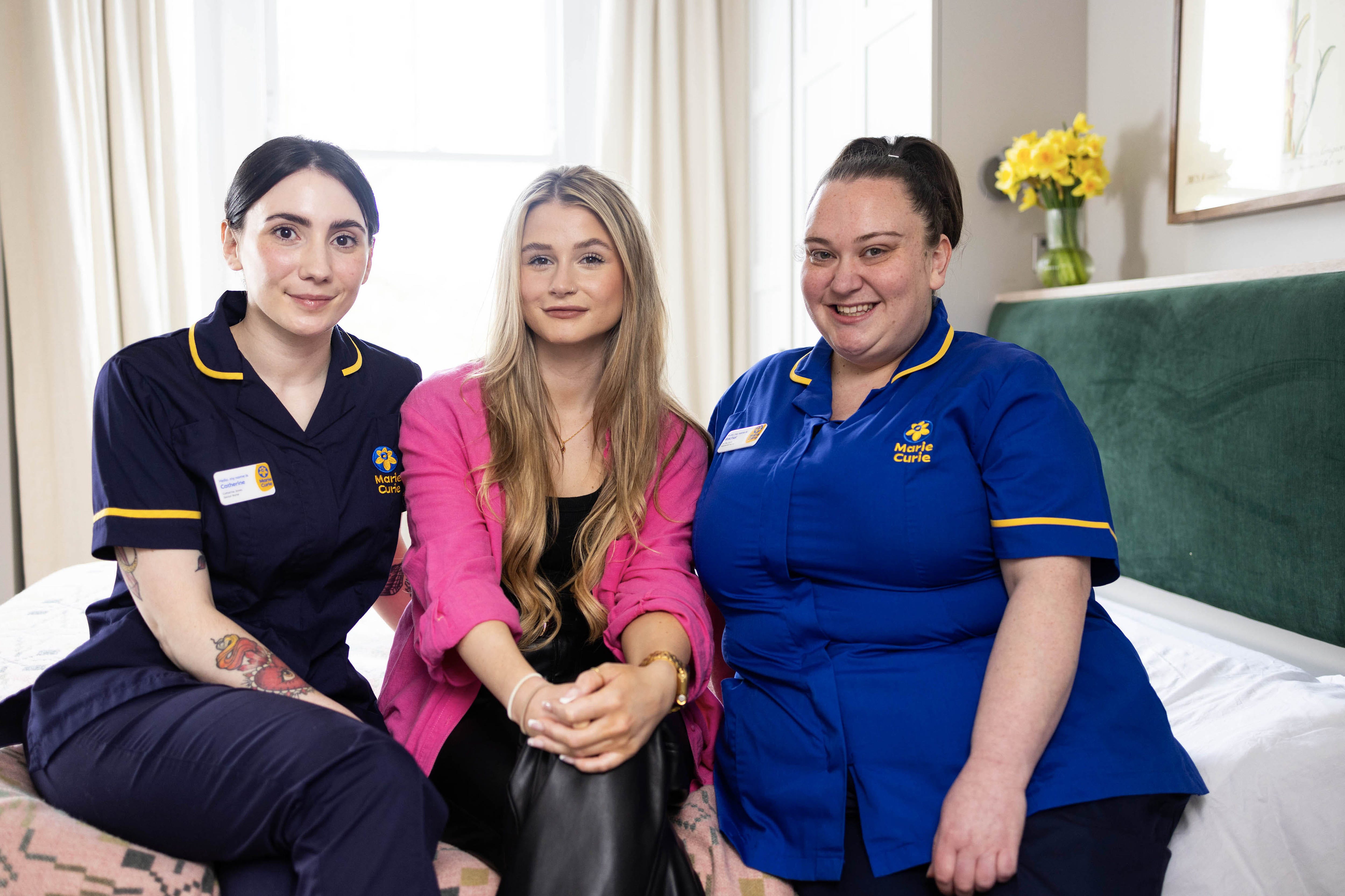 The Traitors star Mollie Pearce (centre) with Marie Curie Nurses Catherine Jones (left) and Rachel Scott (David Parry/PA)