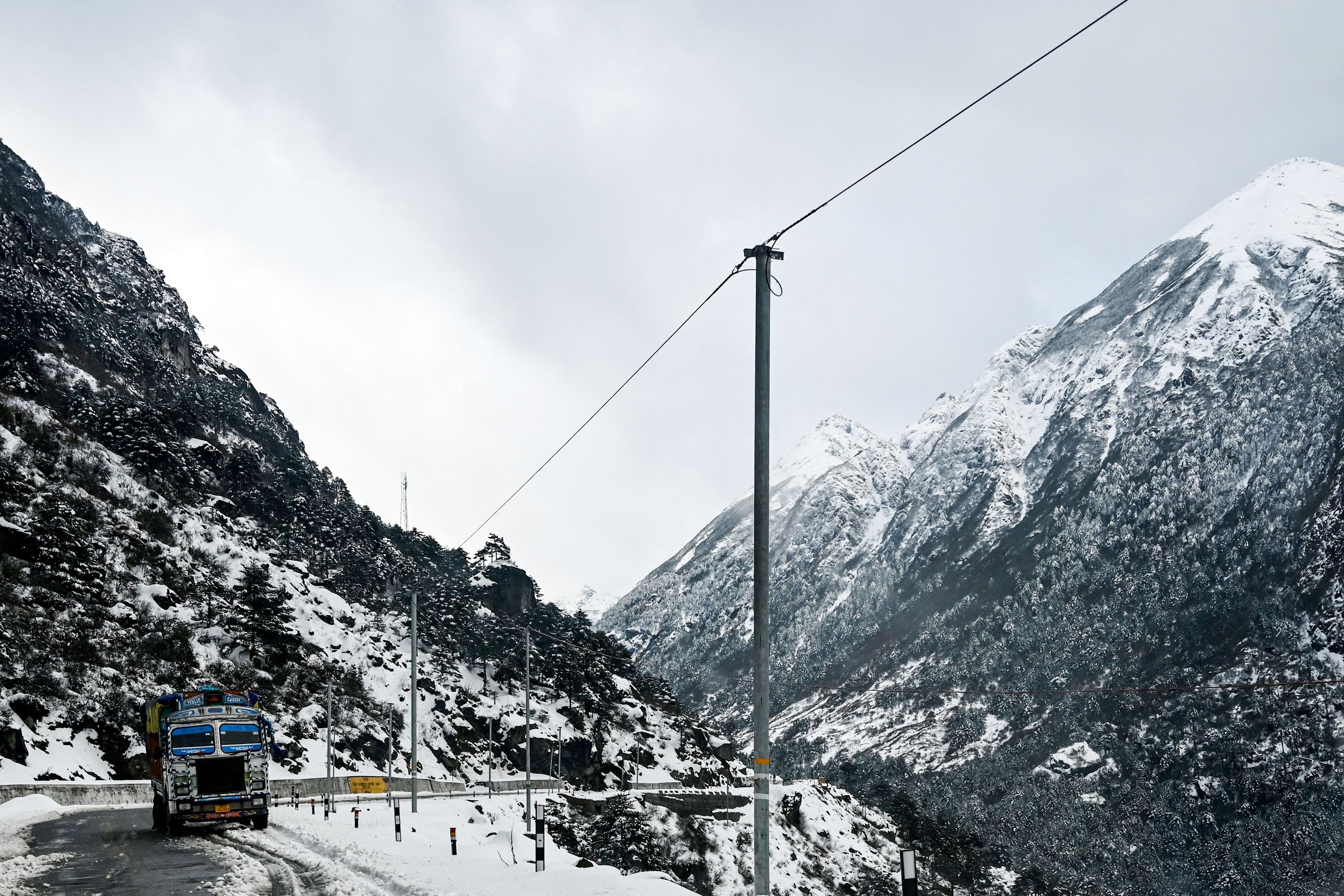 <p>A truck passes a highway in Tawang, Arunachal Pradesh</p>