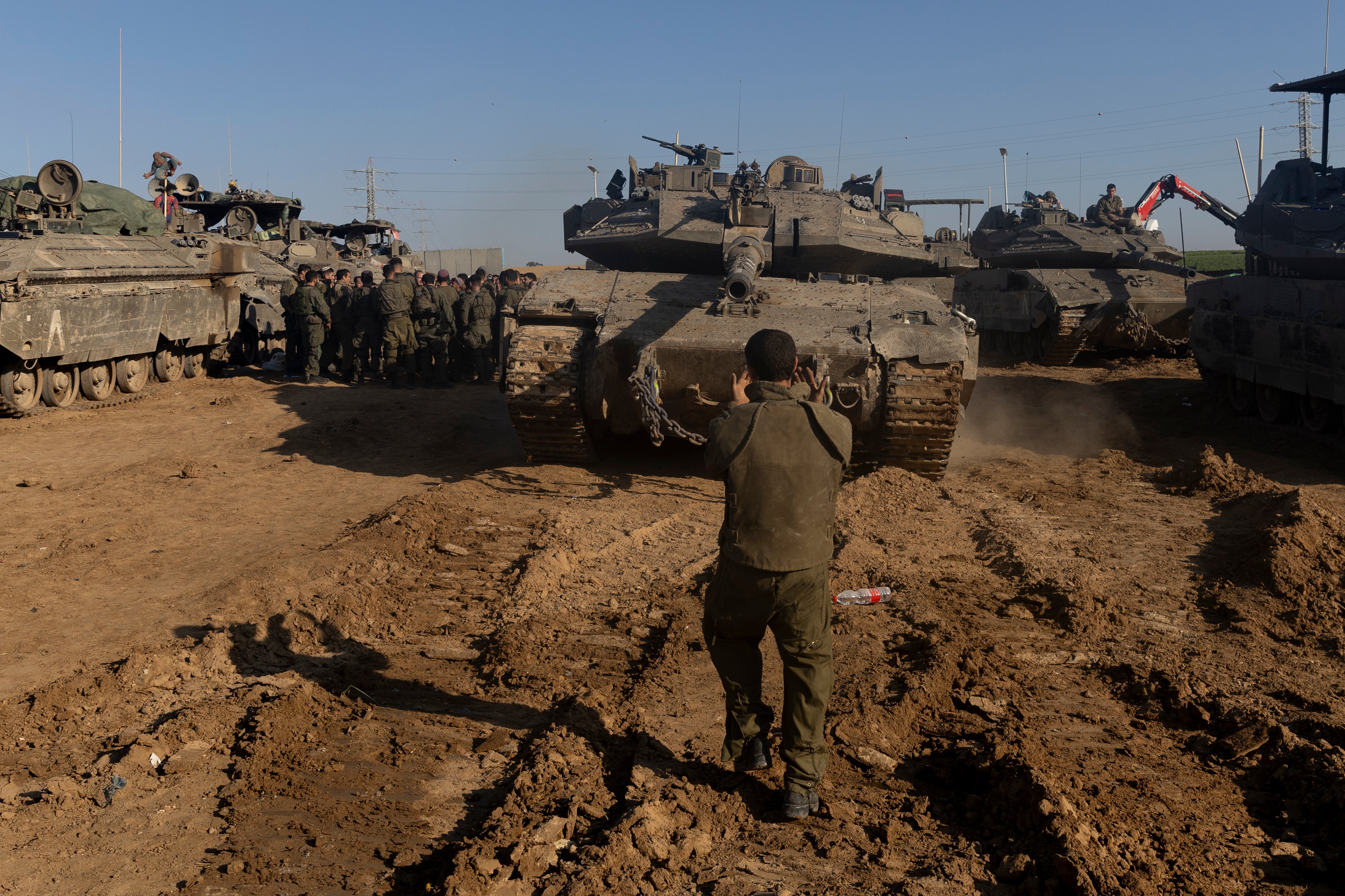 An Israeli soldier directs a tank near the border with the Gaza Strip