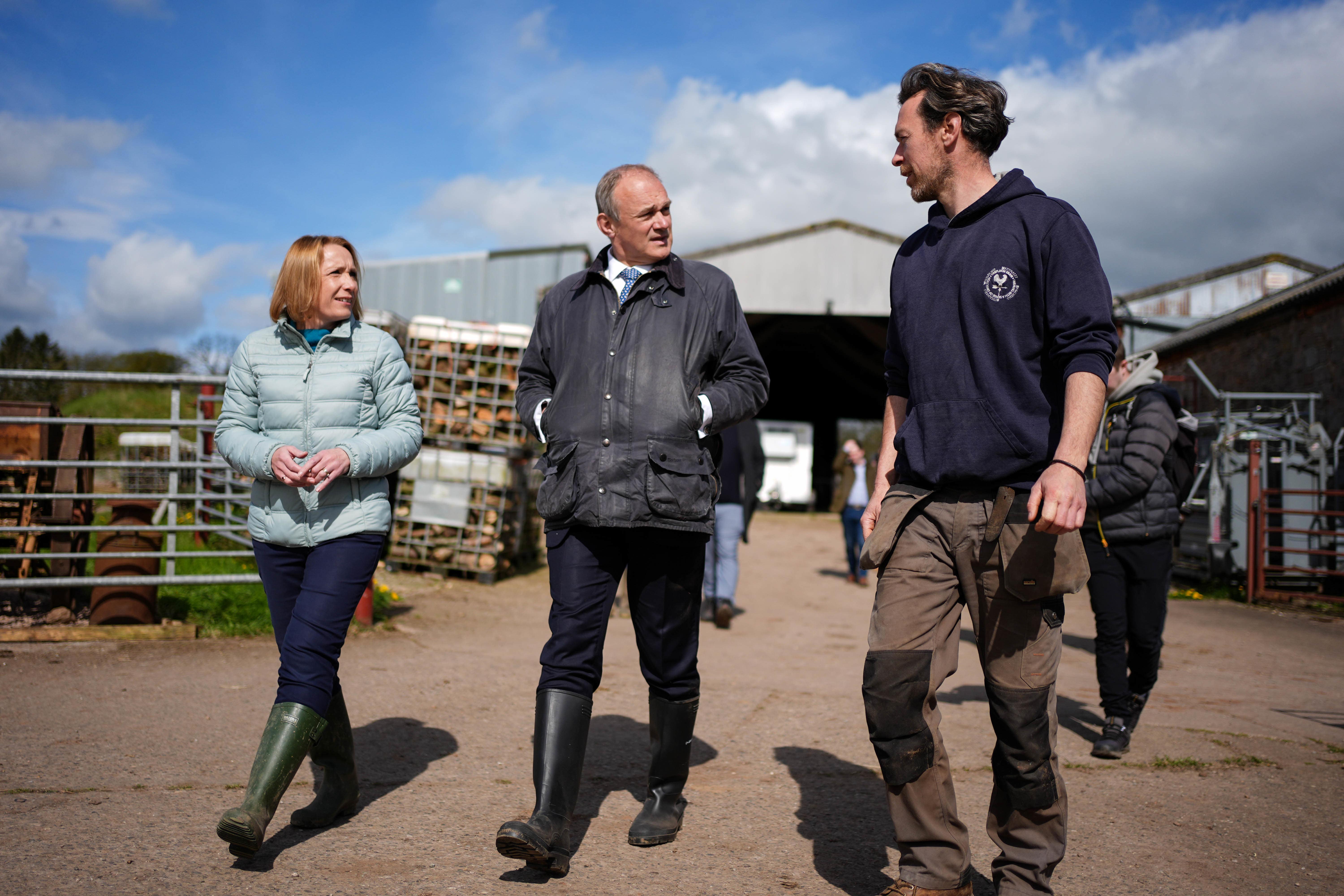 Liberal Democrat leader Sir Ed Davey (centre) and Helen Morgan, MP for North Shropshire, during a visit to Treflach Farm in Treflach, Shropshire (Jacob King/PA)