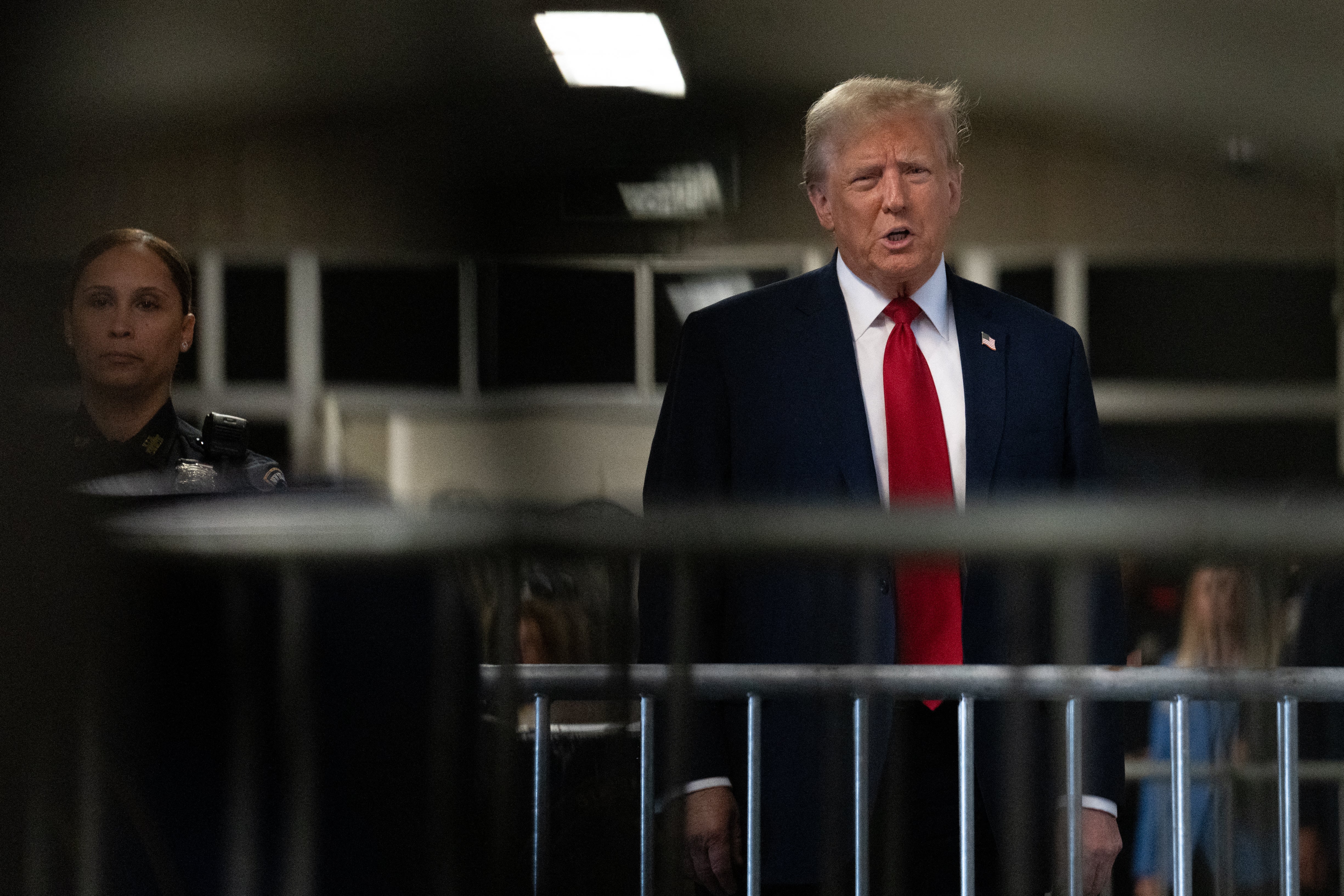 Donald Trump speaks to reporters in a Manhattan criminal court hallway on 25 April