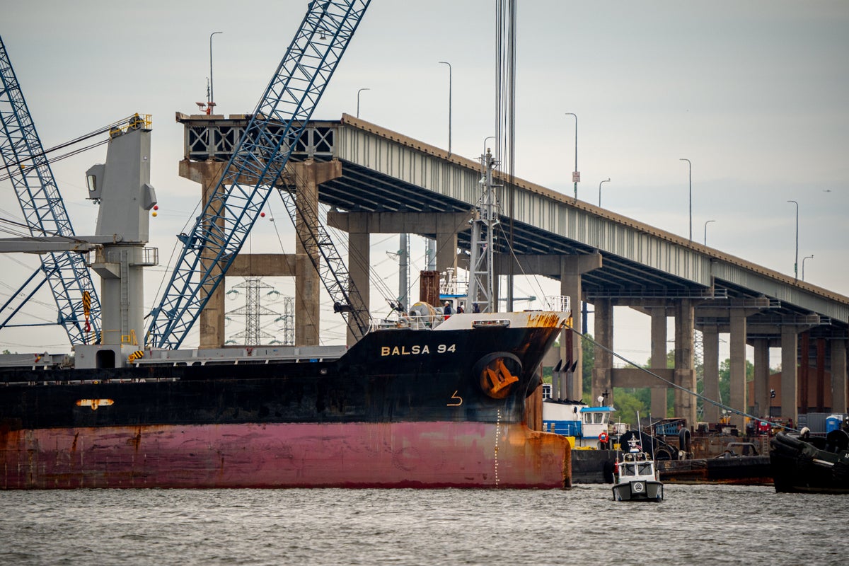 First ship passes through new channel alongside Baltimore bridge wreckage and stranded Dali